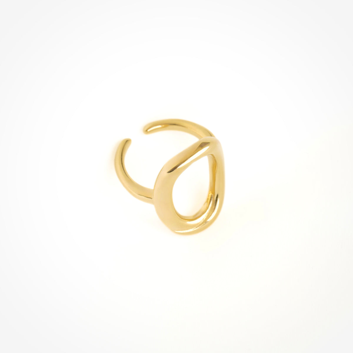 A polished gold open wrap ring with a minimalist, organic loop design, photographed on a seamless white background.