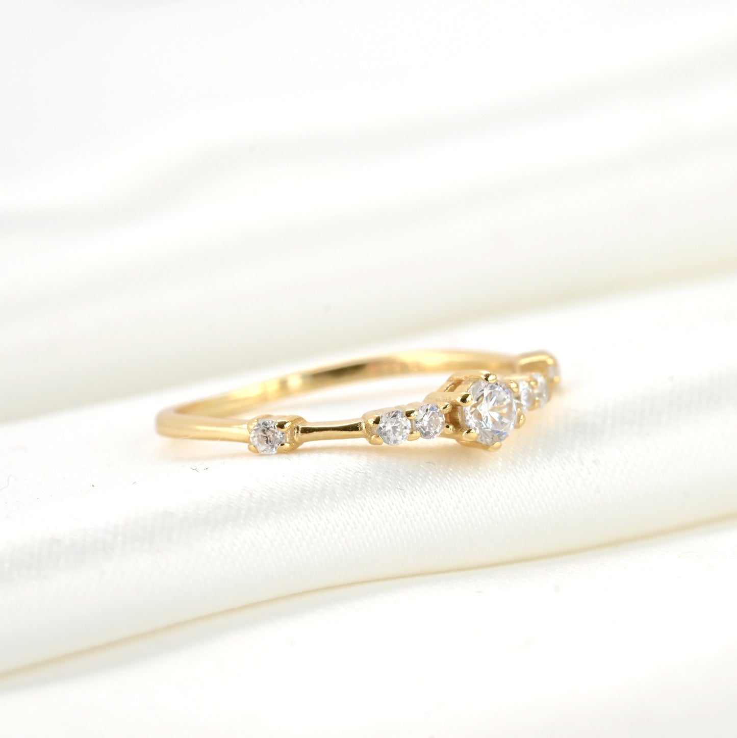 Gold ring with diamonds on a white background