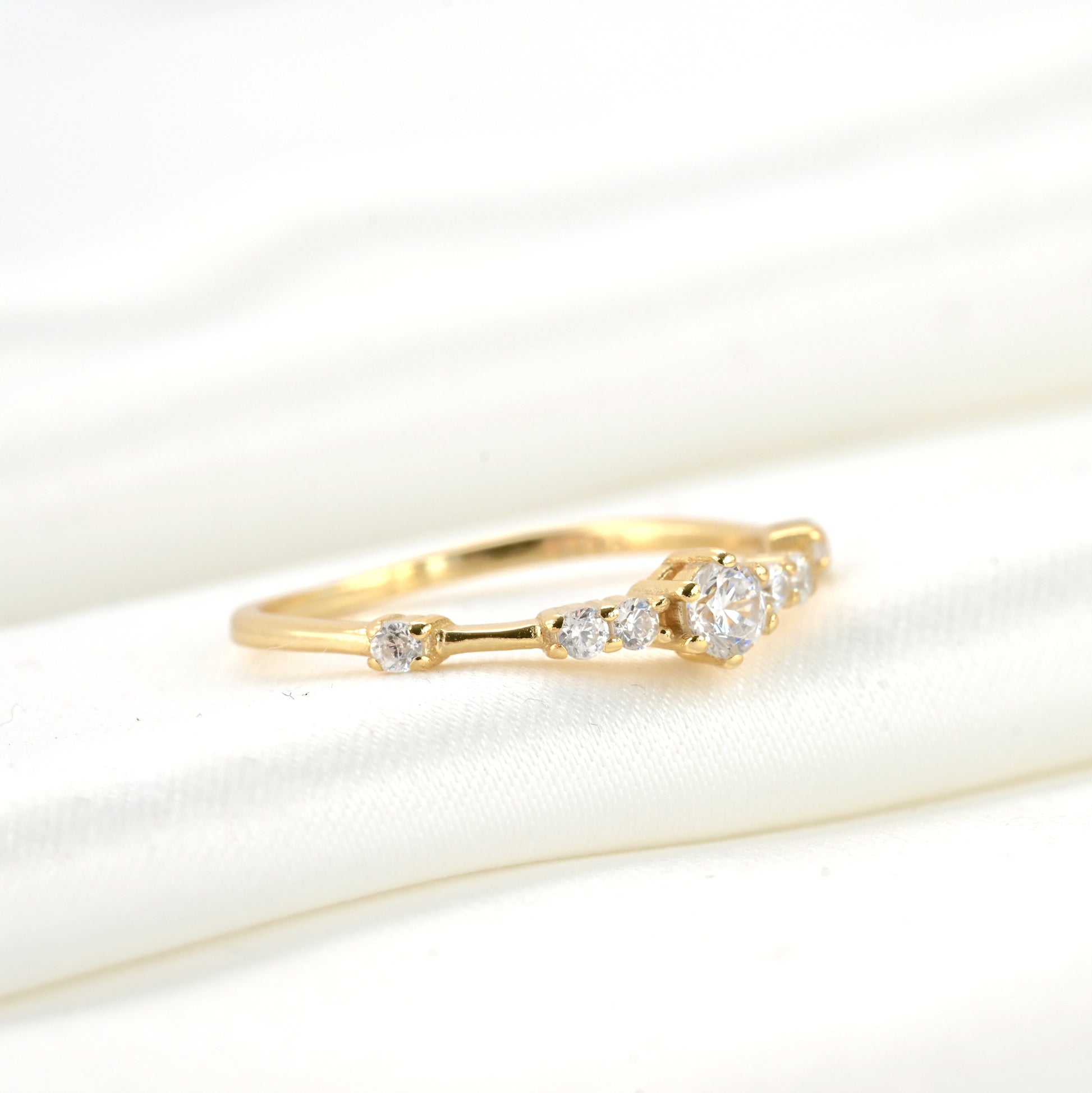 Gold ring with diamonds on a white background