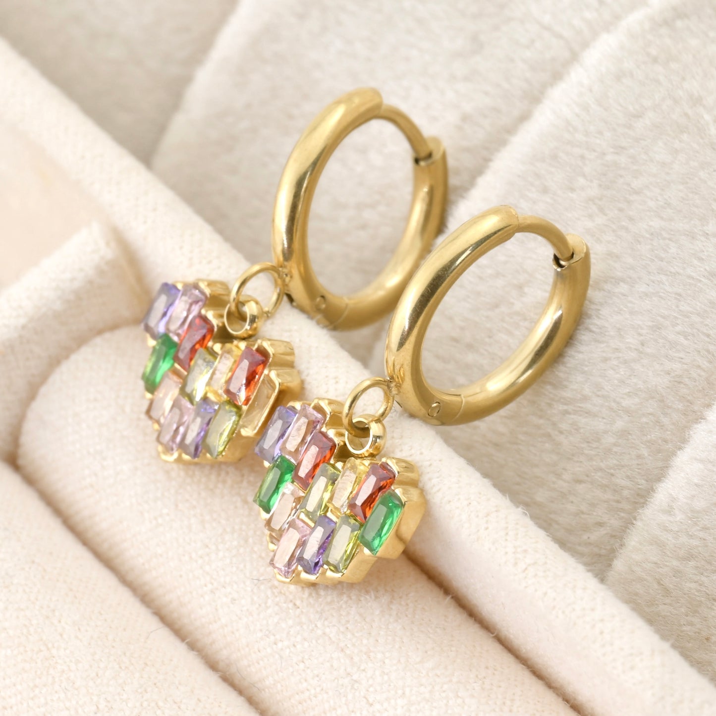 Small gold huggie hoops with rainbow heart charm