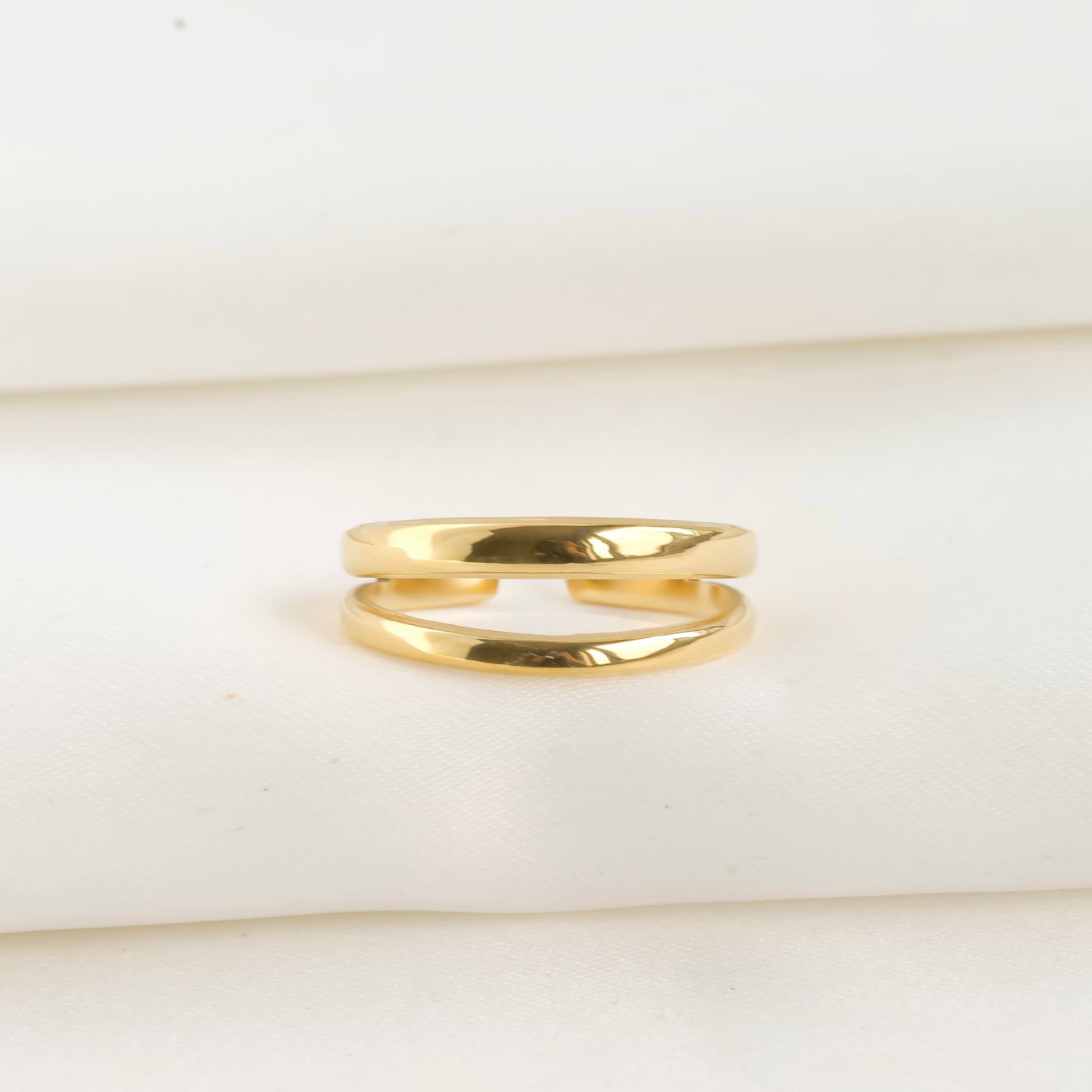 front view of gold ring on a white background