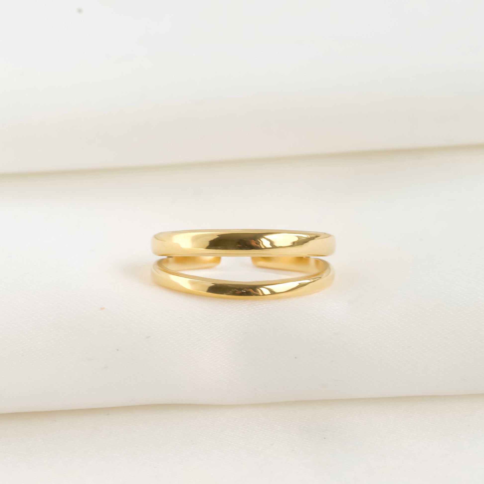 front view of gold ring on a white background