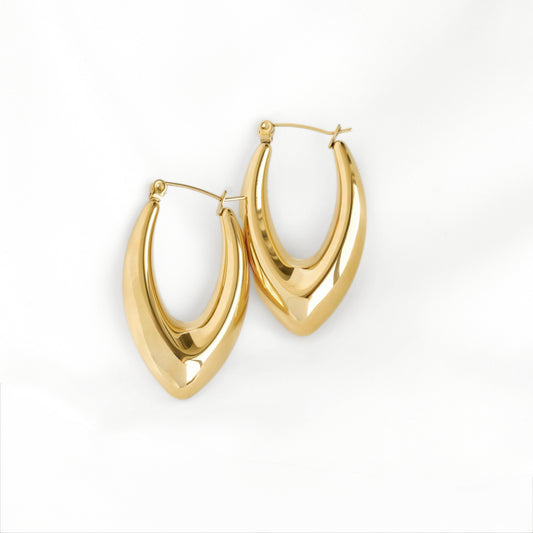 A pair of chunky polished gold-tone hoop earrings with a curved, V-shaped design and latch-back clasps, displayed on a clean white background.