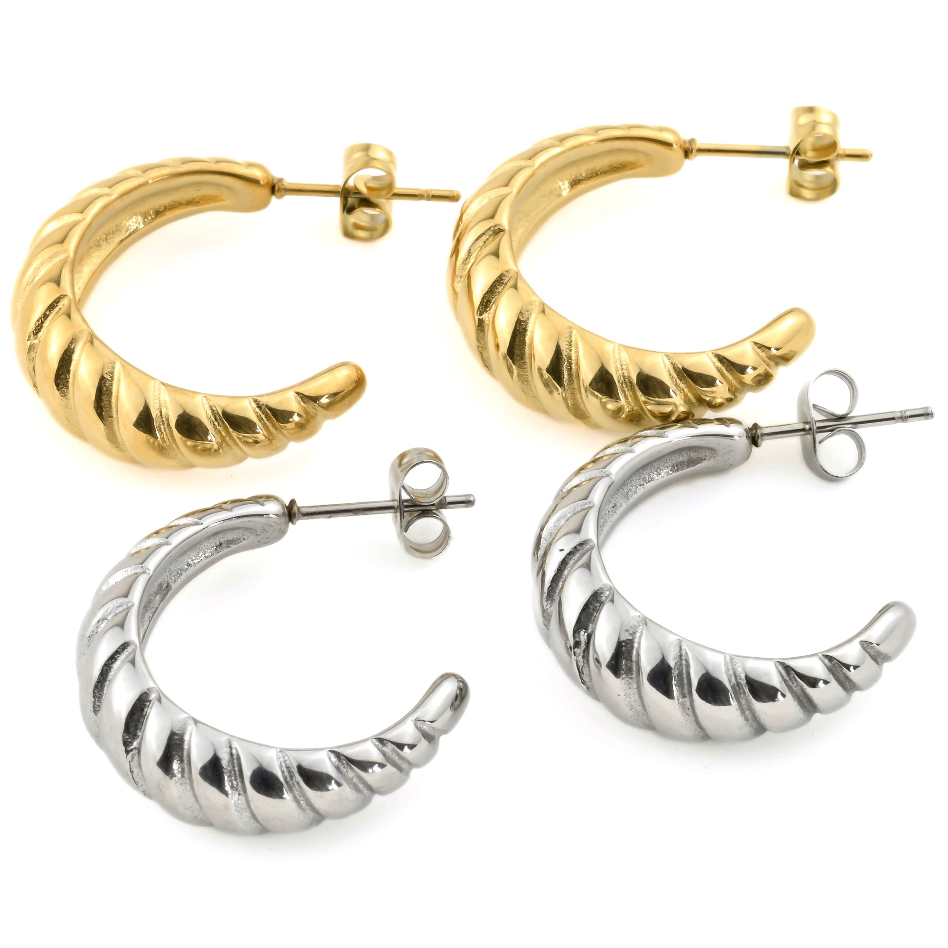 Pair of gold and silver ribbed C hoop earrings on a white background