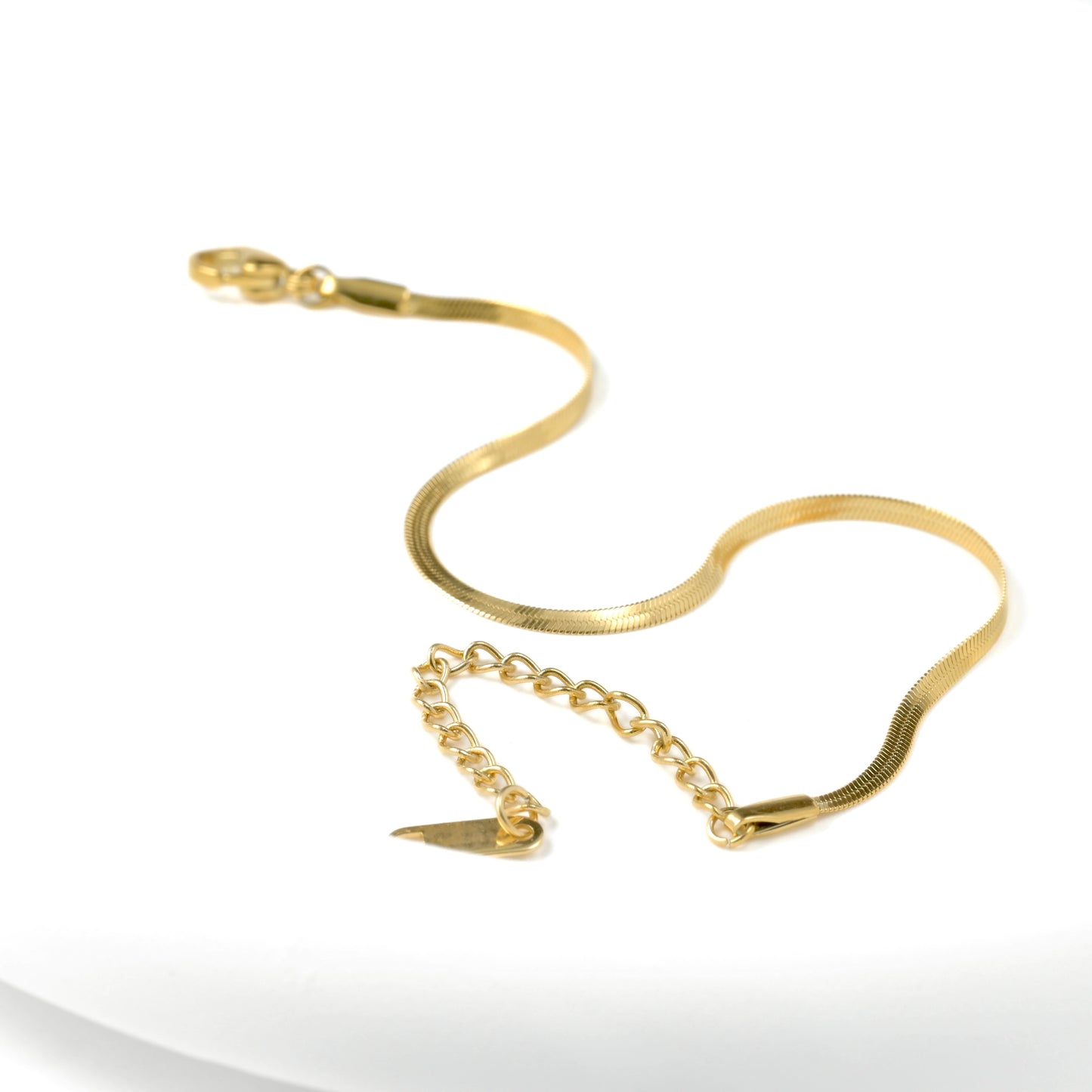 2mm flat herringbone bracelet with a lobster claw clasp and extender on a white background