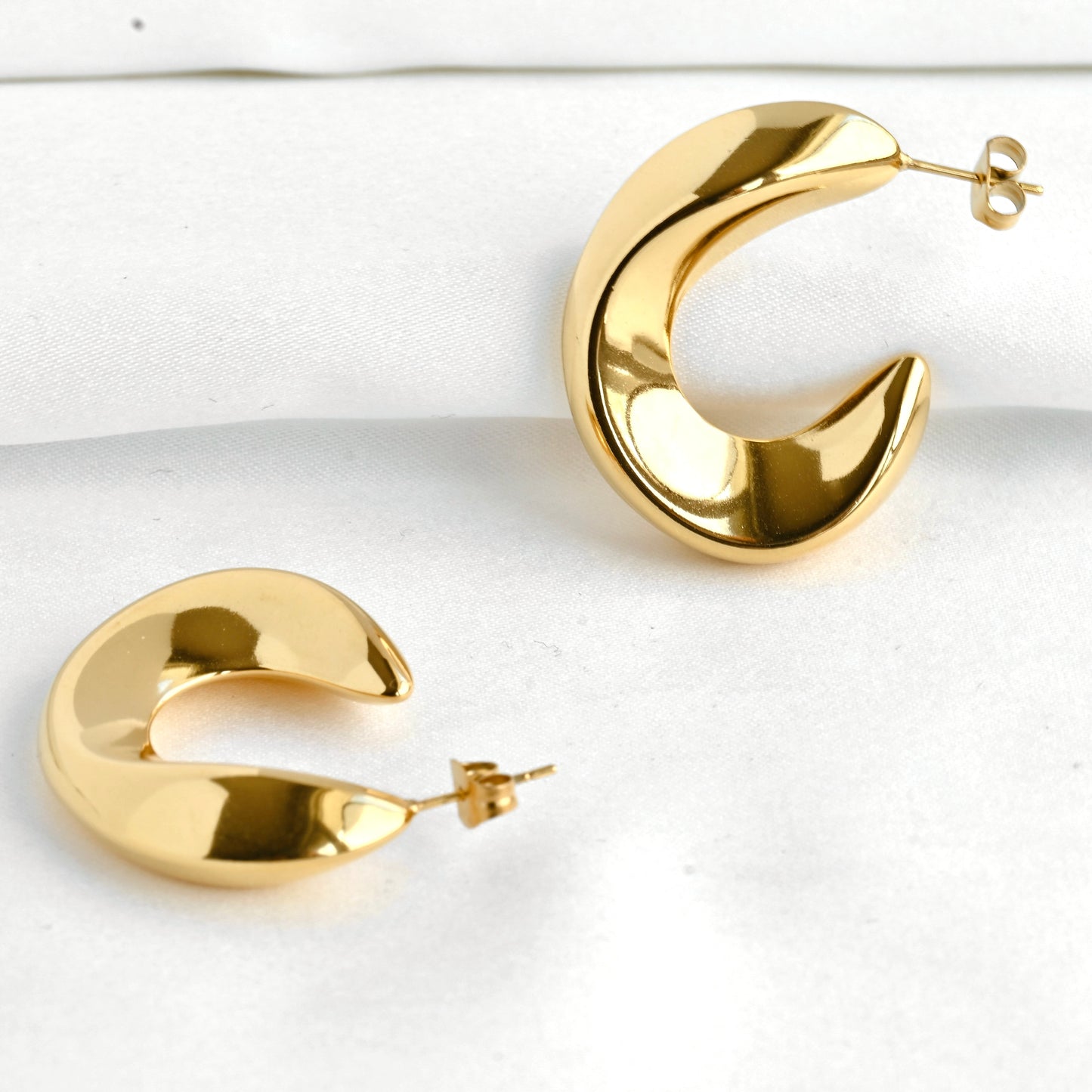 Edgy hoop earrings on a white background