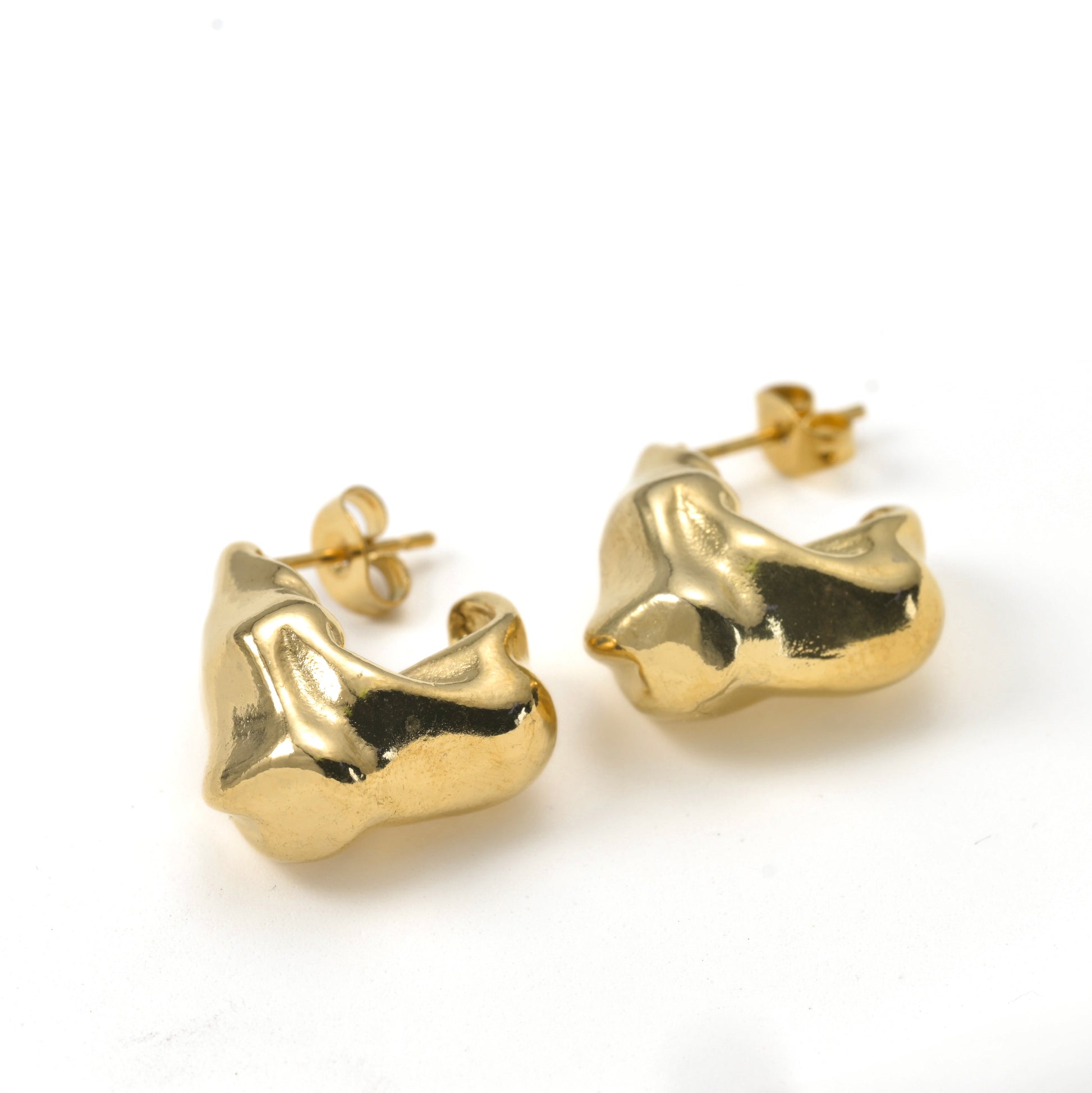 Gold molten drop earrings on a white background