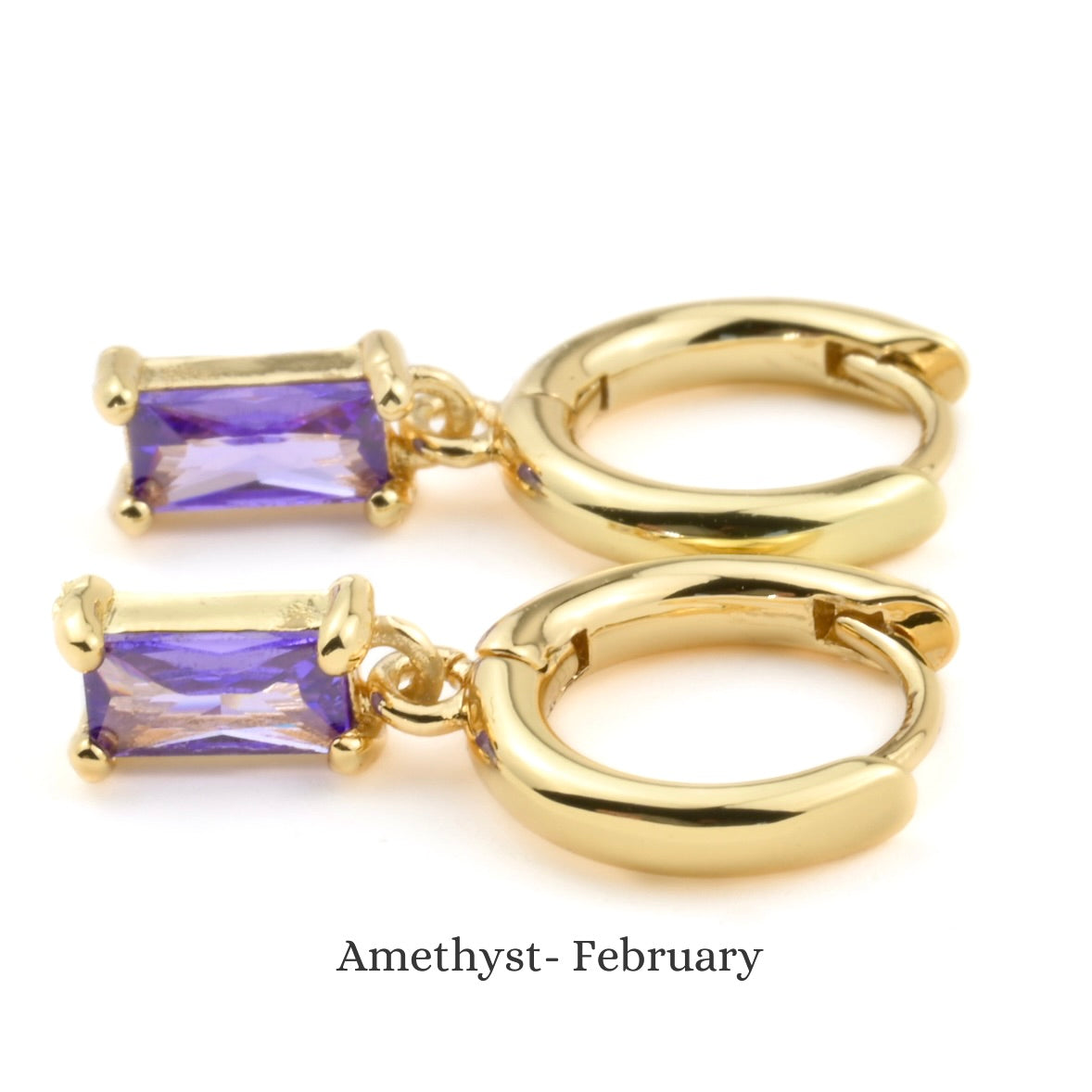 Gold hoop earrings with February birthstone on a white background