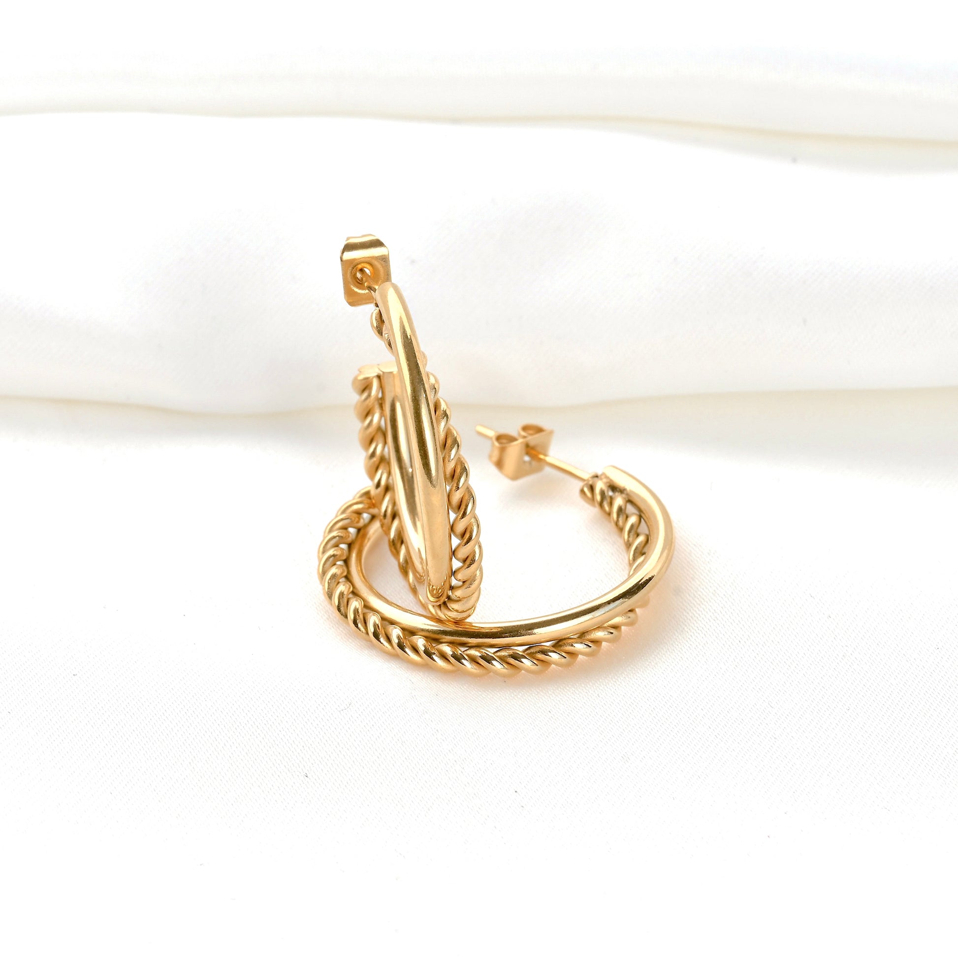 Gold hoop earrings on a white background