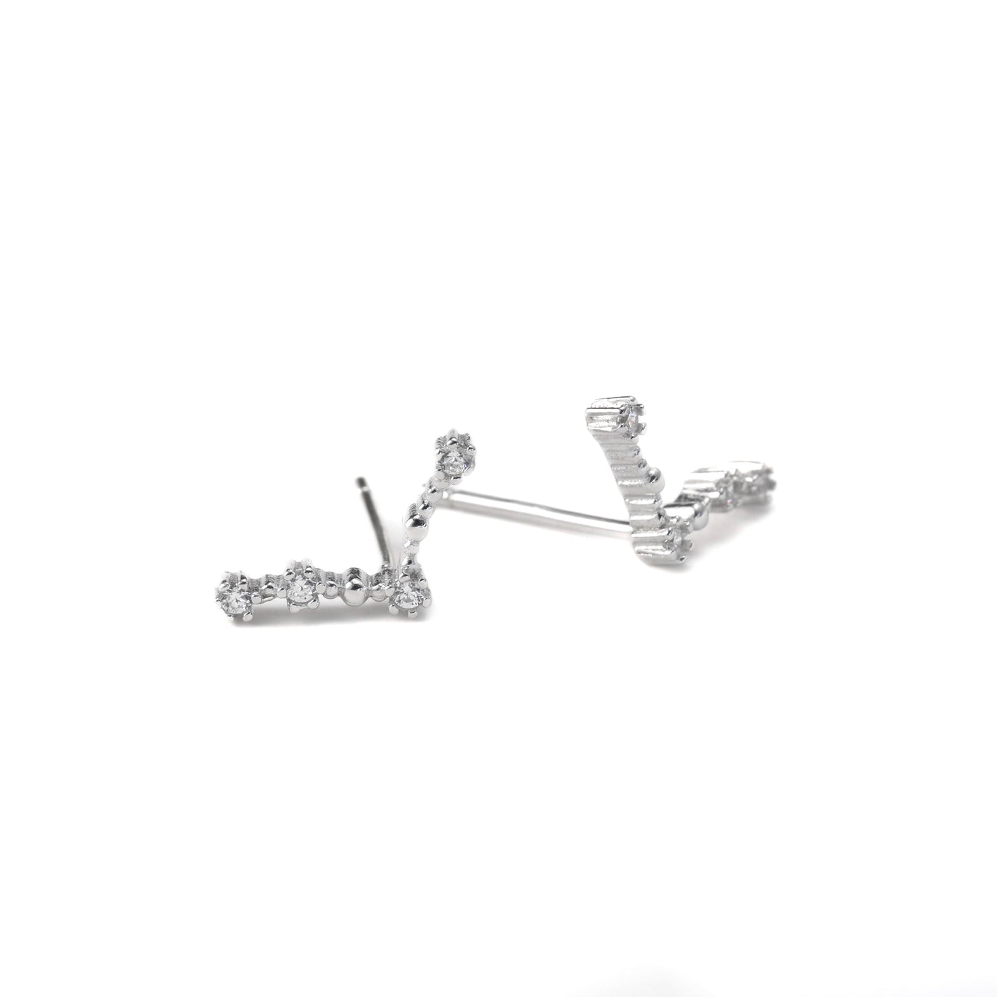a pair of aries constellation stud earrings on a white background