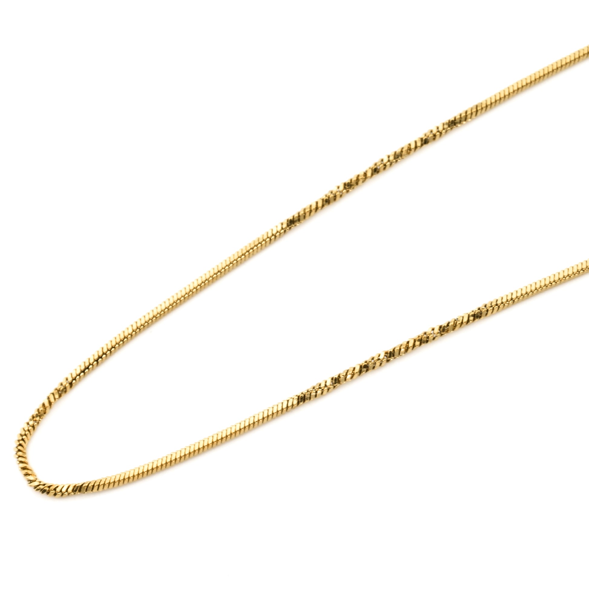 Gold chain necklace with gentle twists on a white background