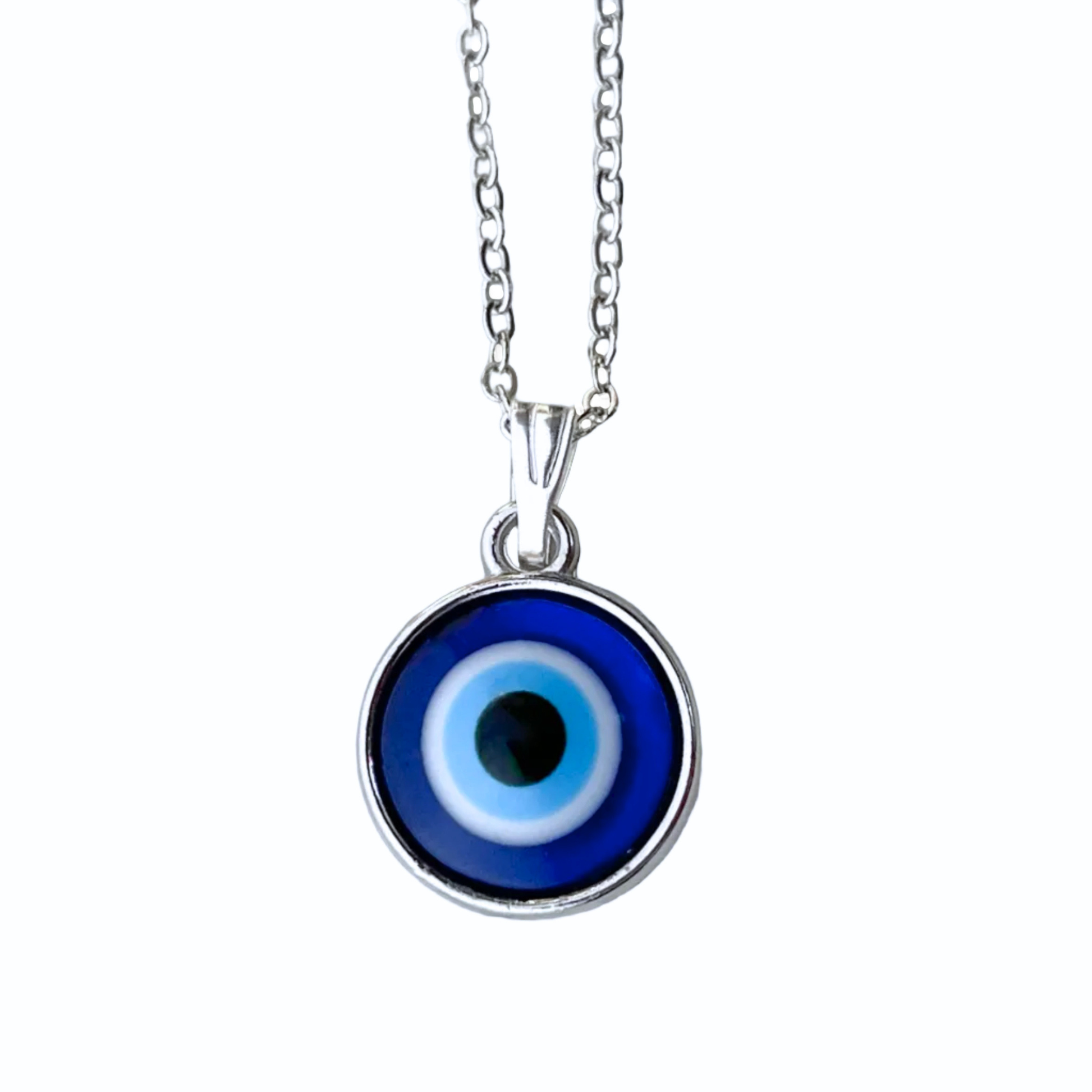 Top view of blue evil eye pendant necklace with a silver cable chain on a white background