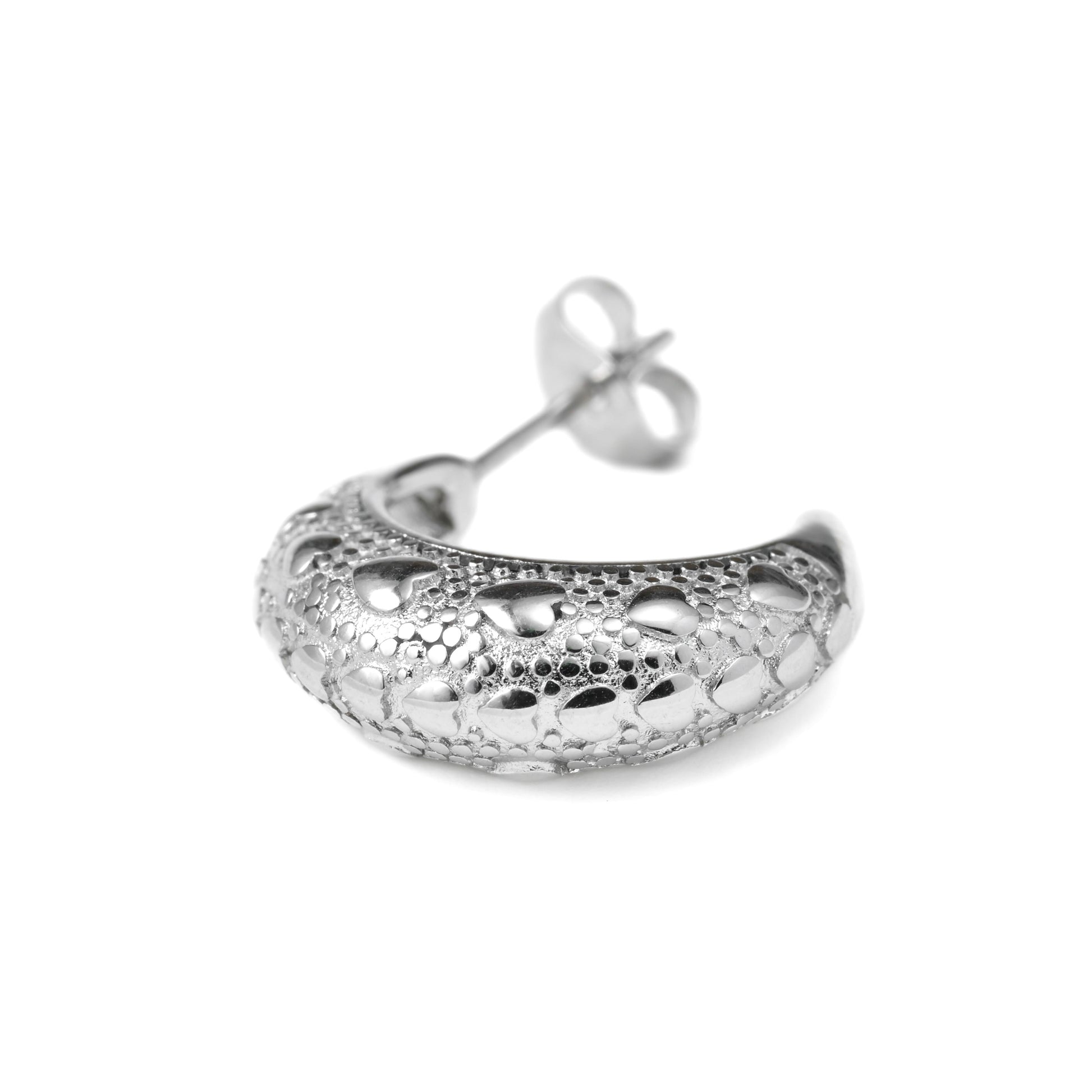 close-up view of the Silver earring withhearts and dots on a white background