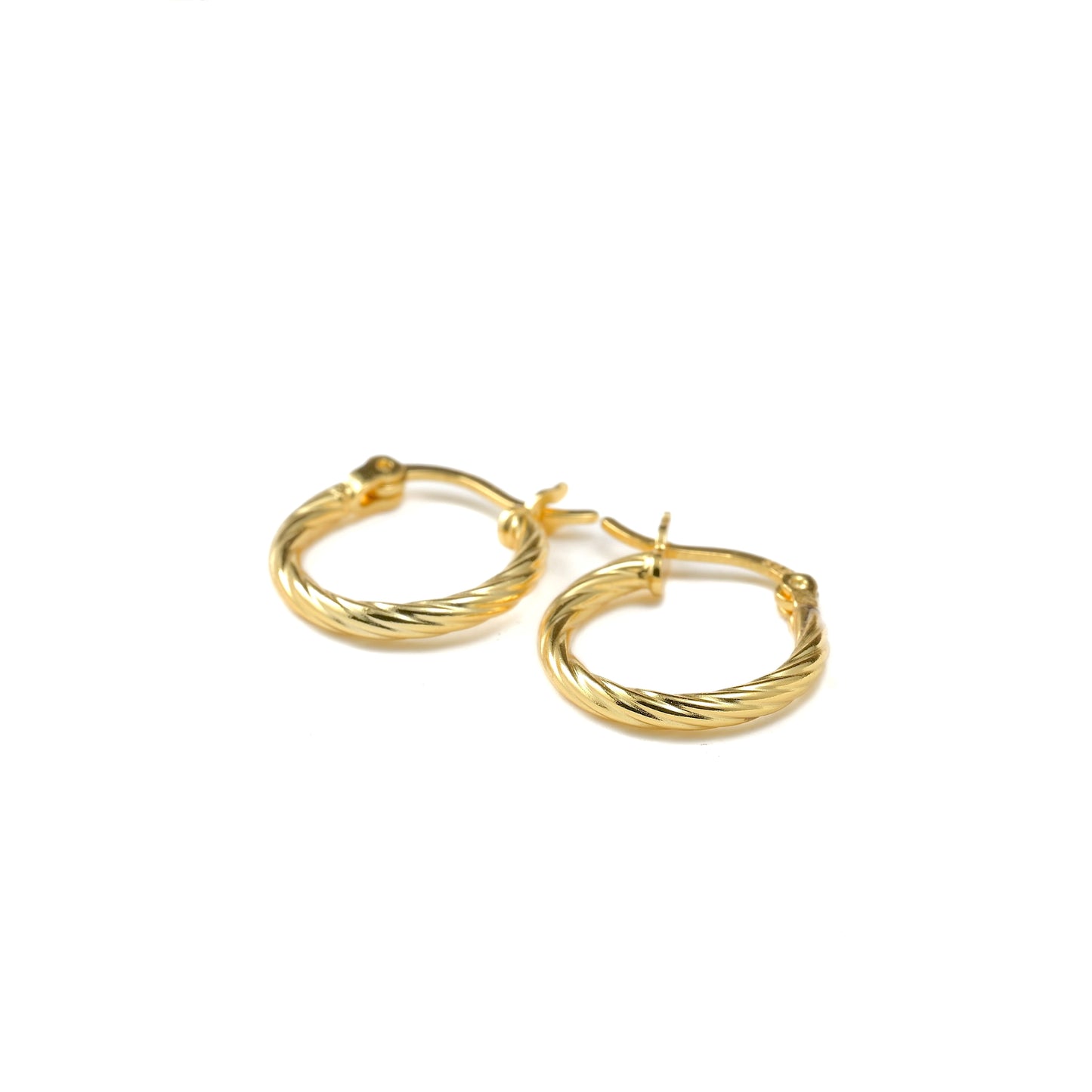 Close-up of textured gold hoop earrings on a white background
