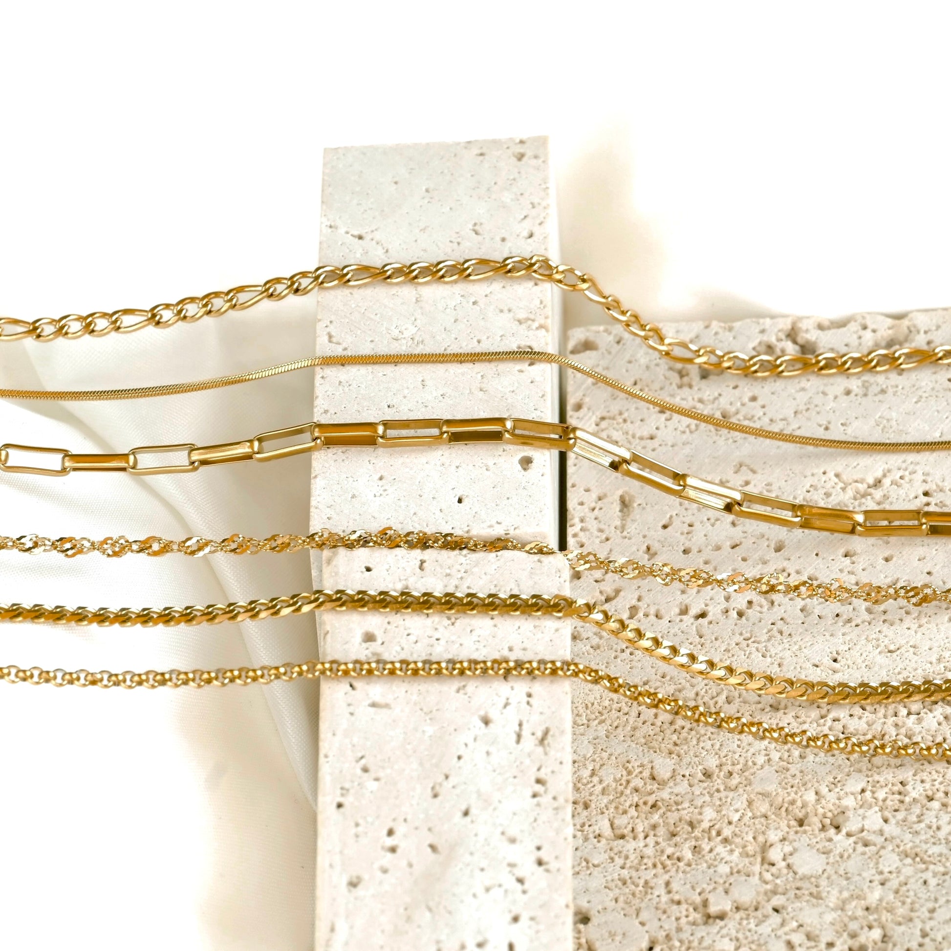horizontal view of chains on a textured stone surface