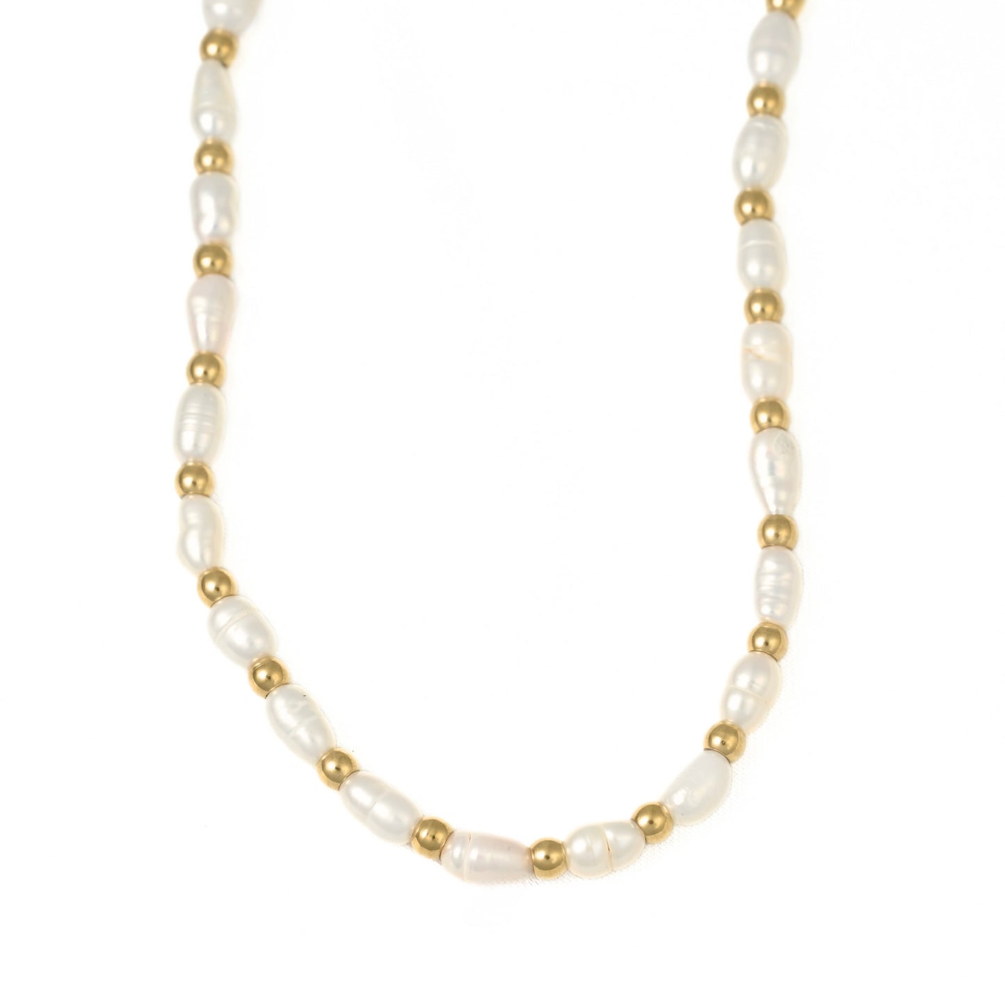 A delicate necklace featuring irregular white baroque pearls separated by small metallic gold beads, displayed on a clean white background.
