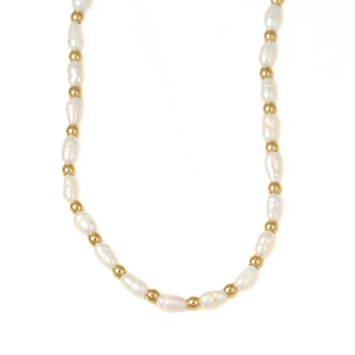 A delicate necklace featuring irregular white baroque pearls separated by small metallic gold beads, displayed on a clean white background.