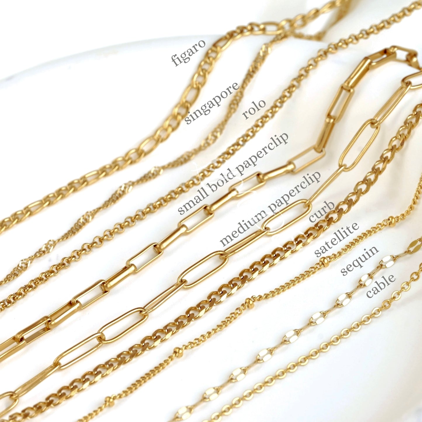Gold chains with various designs on a white background