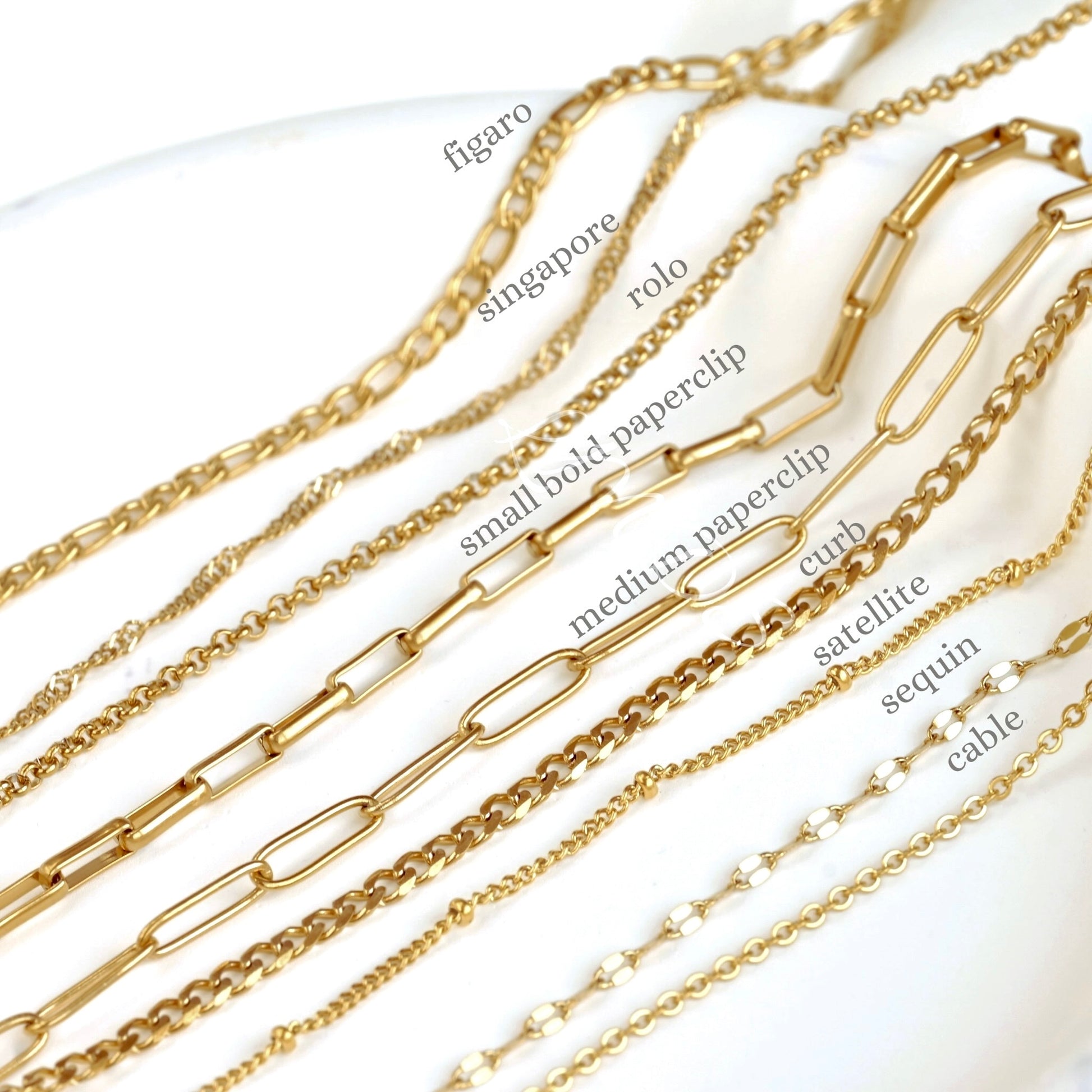 Gold chains with various designs on a white background
