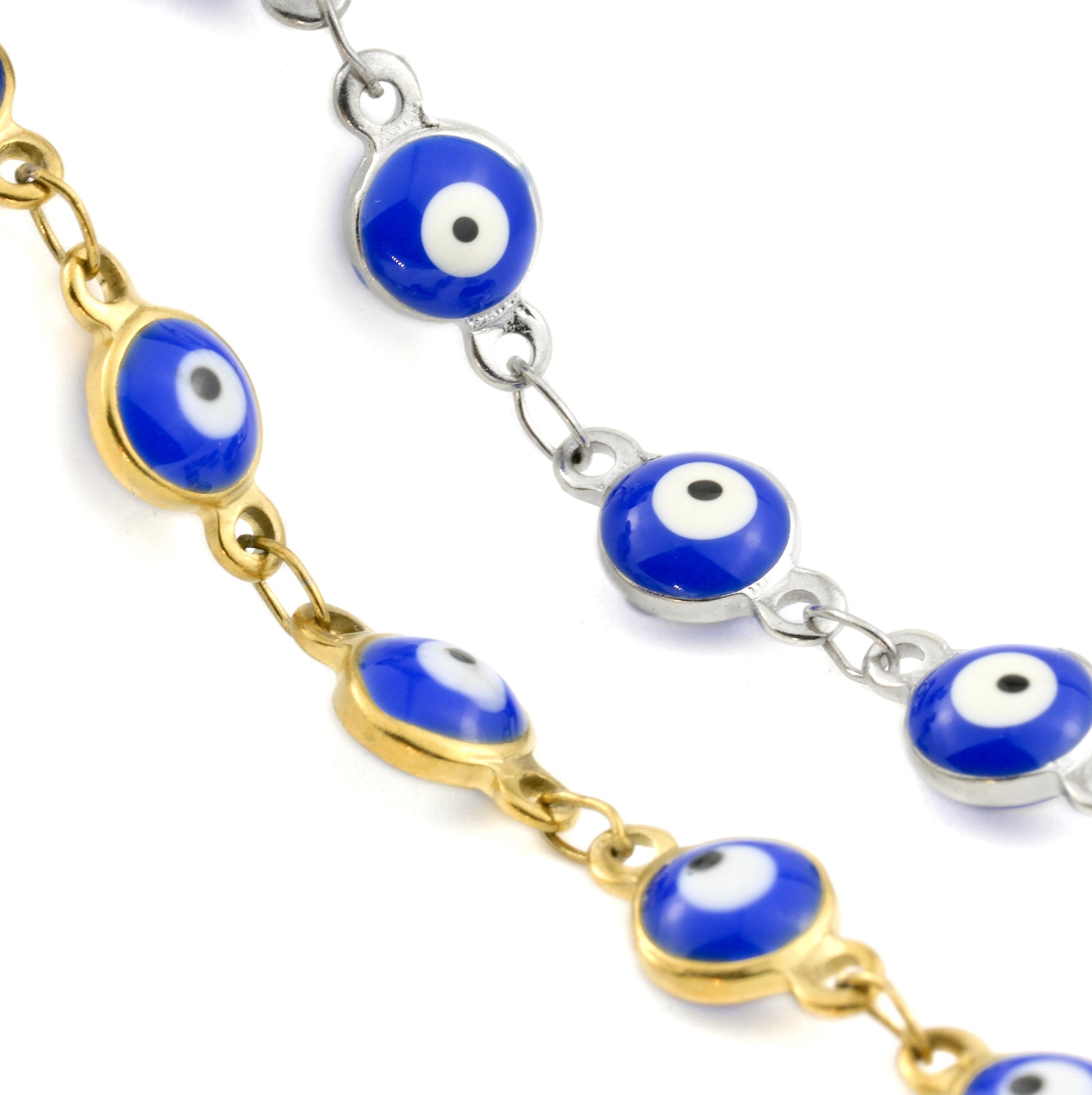 Close-up view of the enamel blue evil eye connector charms  in gold and silver on a white background