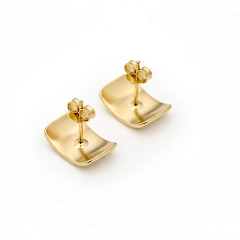 A pair of gold stud earrings with a curved, shield-like face and a small butterfly-shaped backings, shown on a clean white background.