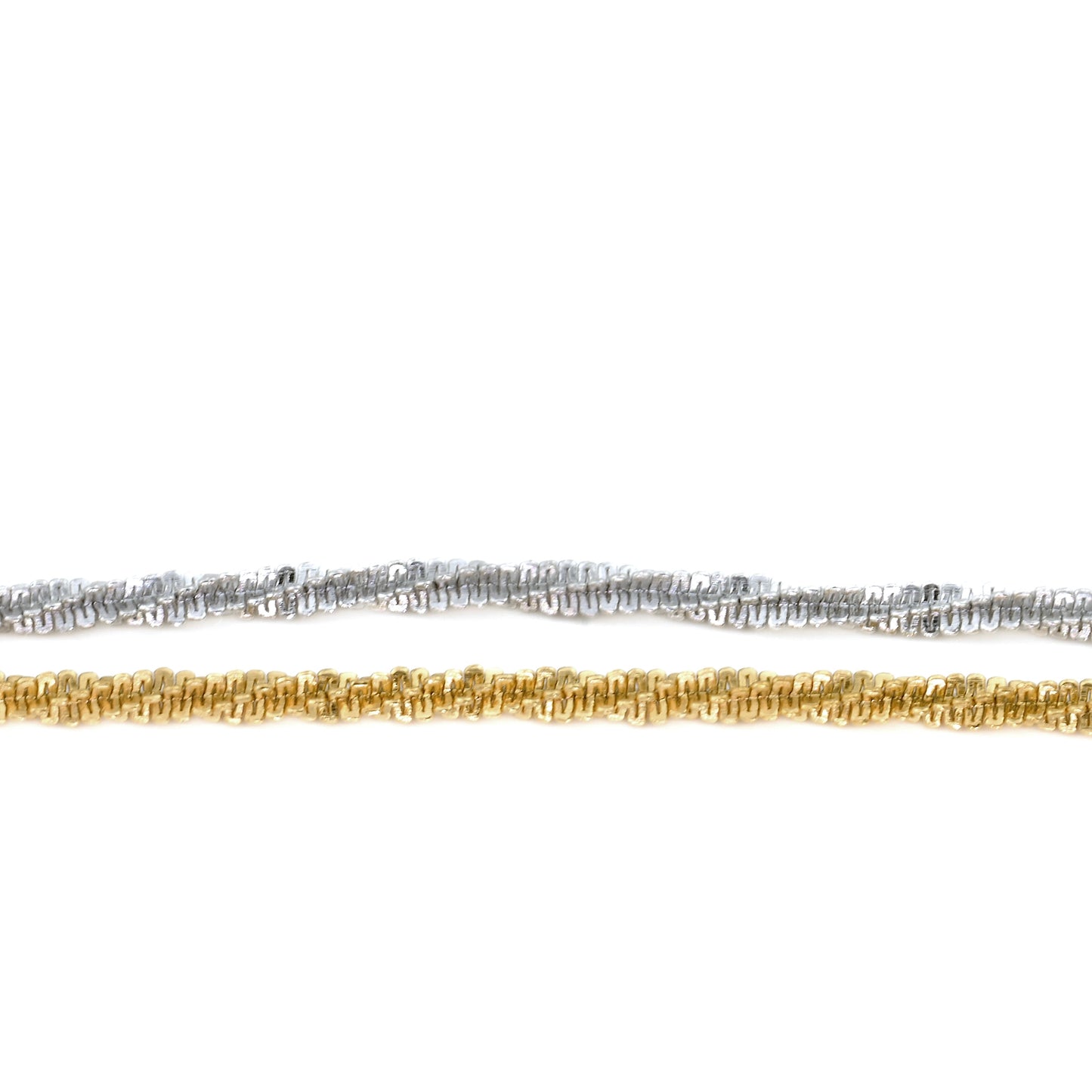 Close-up view of Two gold and silver chains horizontally placed on a white background