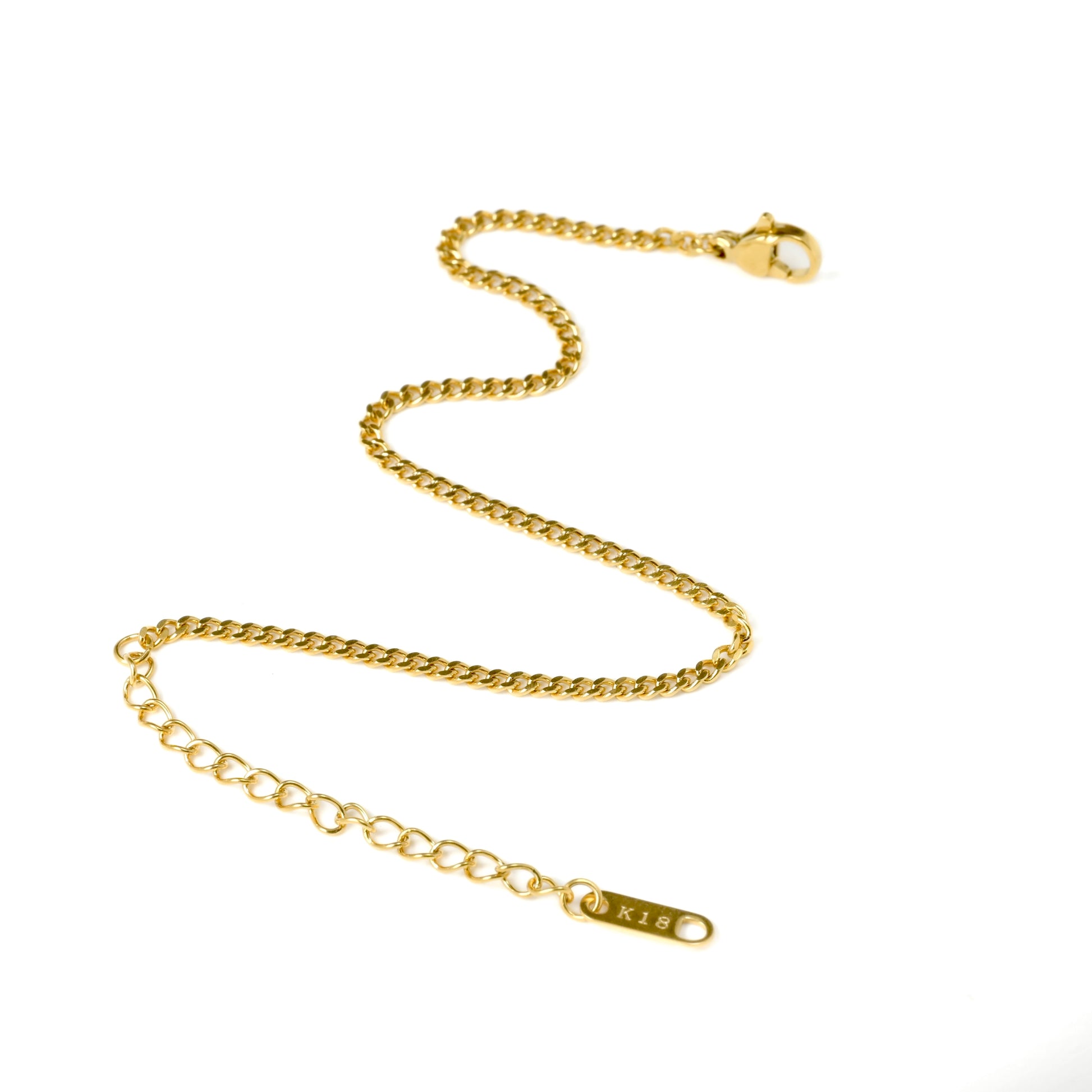 Dainty cuban chain bracelet with a lobster claw clasp and K18 plating tag at the  end, on a white background