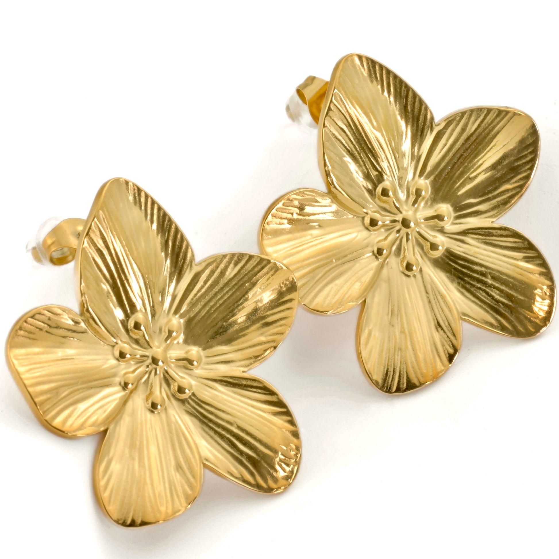 Pair of gold floral earrings on a white background