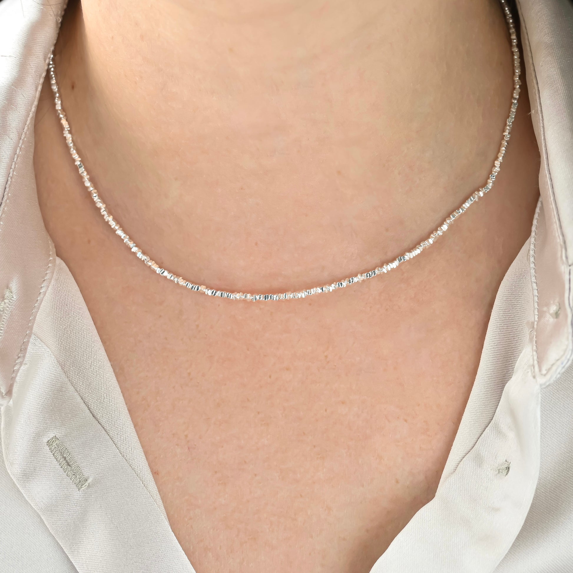 front view of the silver necklace on a person