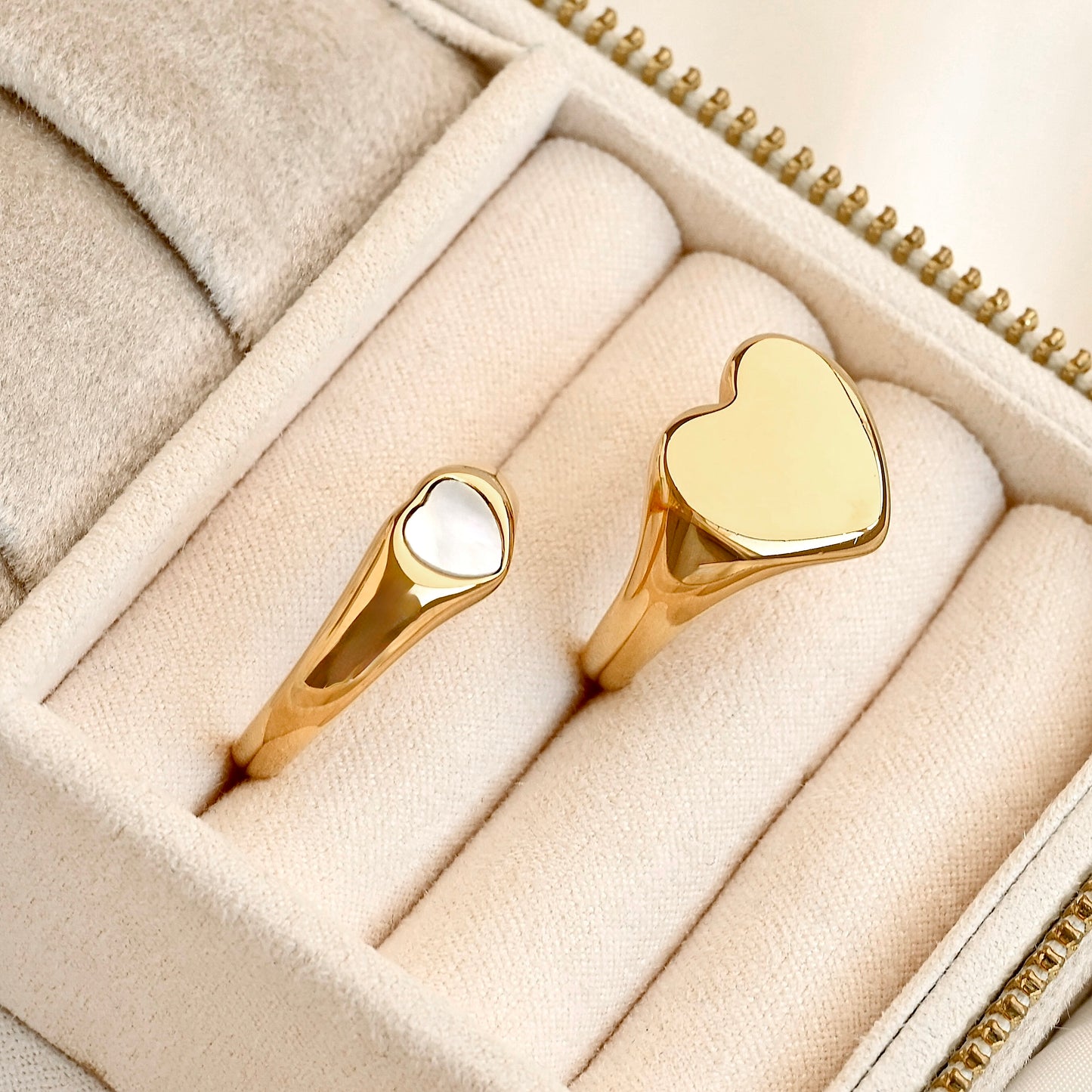 Two bold heart rings in a jewelry box