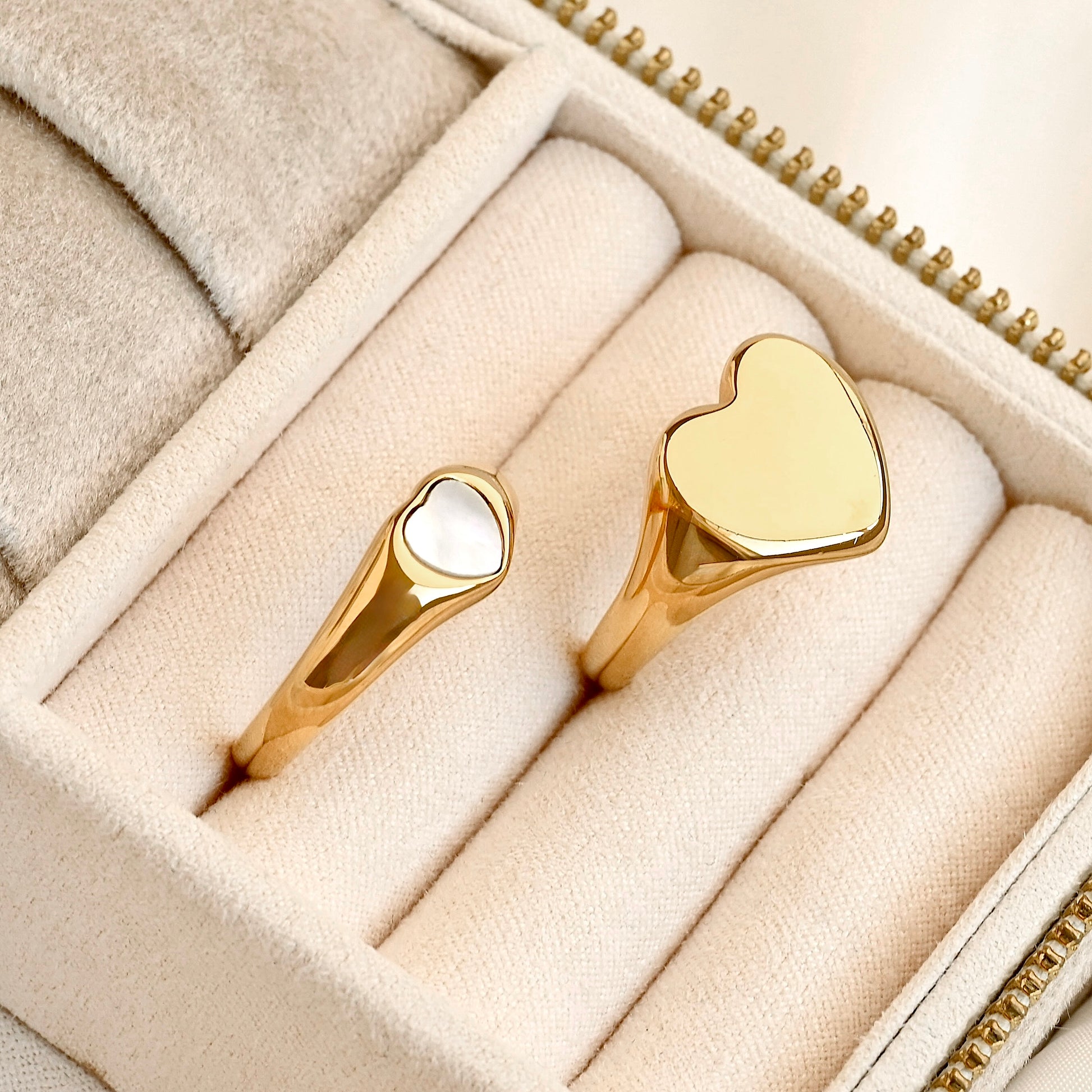Two bold heart rings in a jewelry box