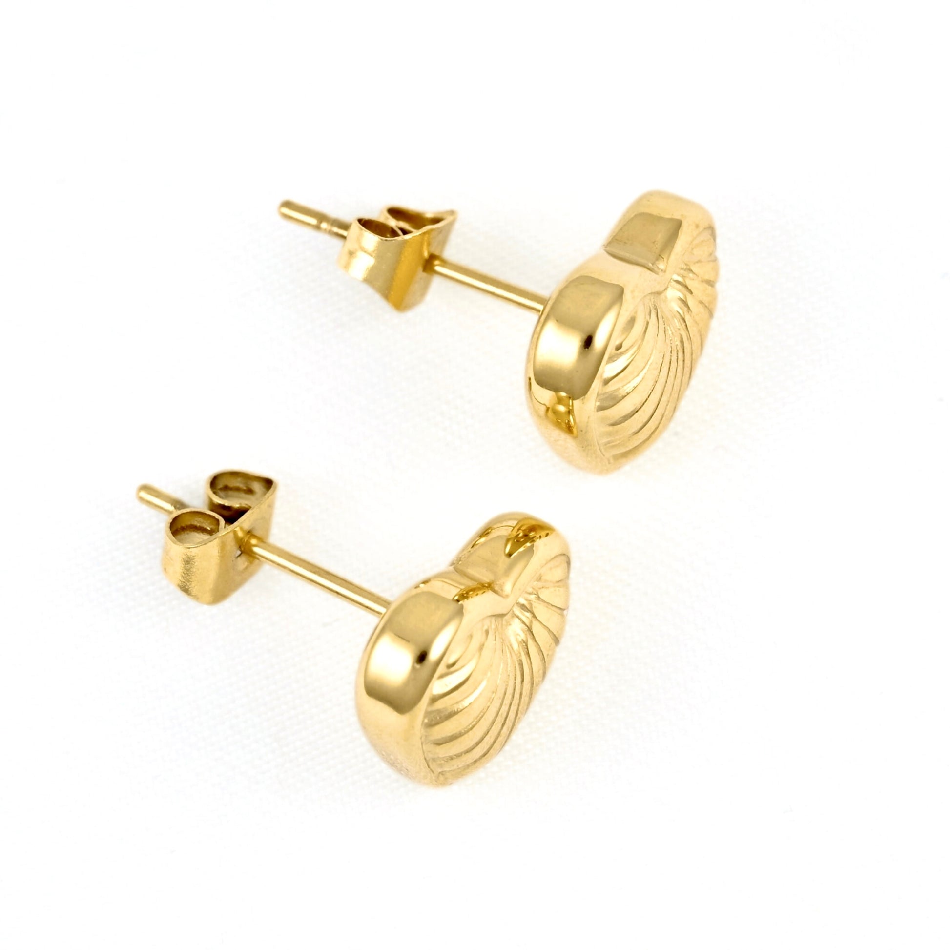 A pair of gold stud earrings with a textured, ribbed oval face and post-back closures, shown on a clean white background.