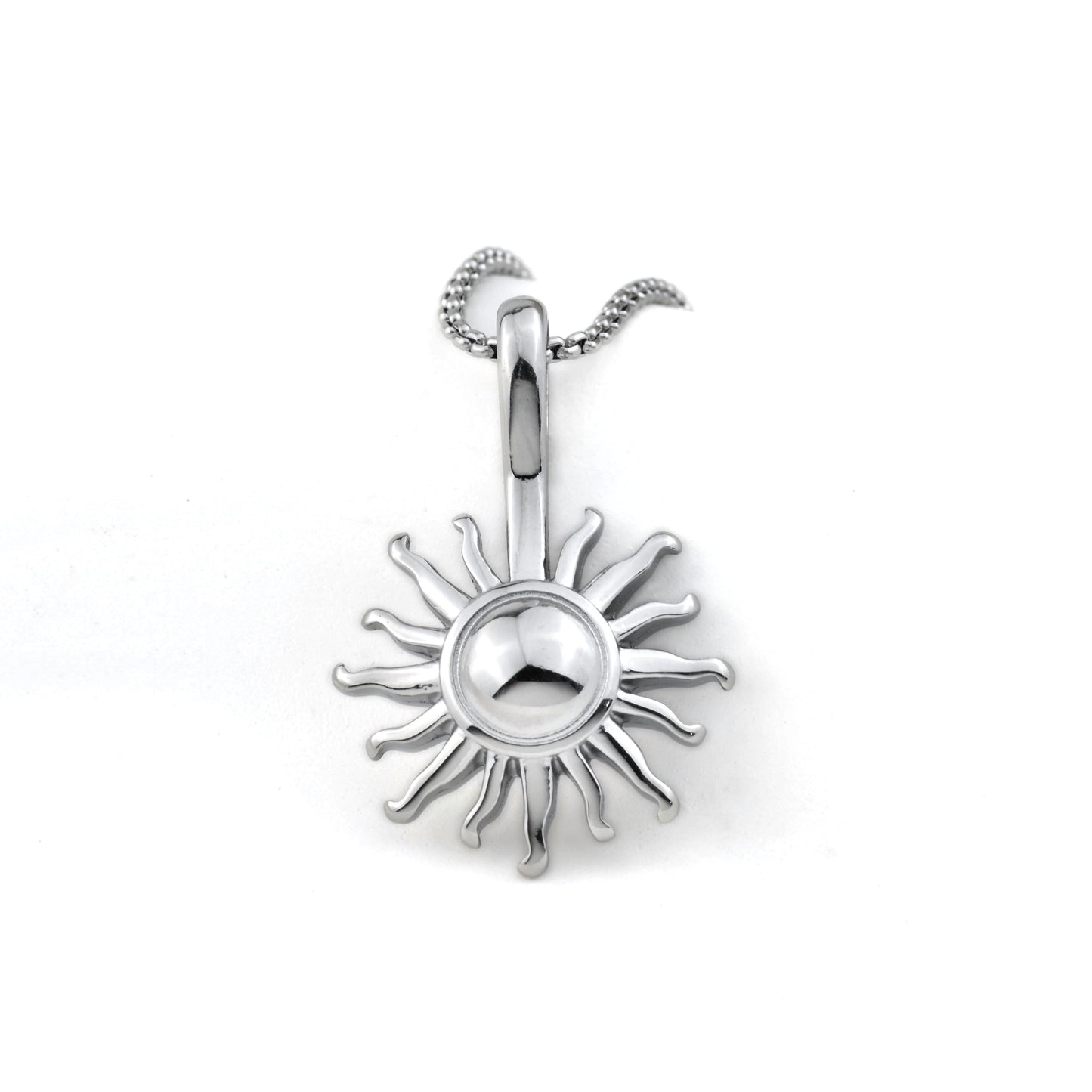 Close up front view of silver sun pendant on a white background