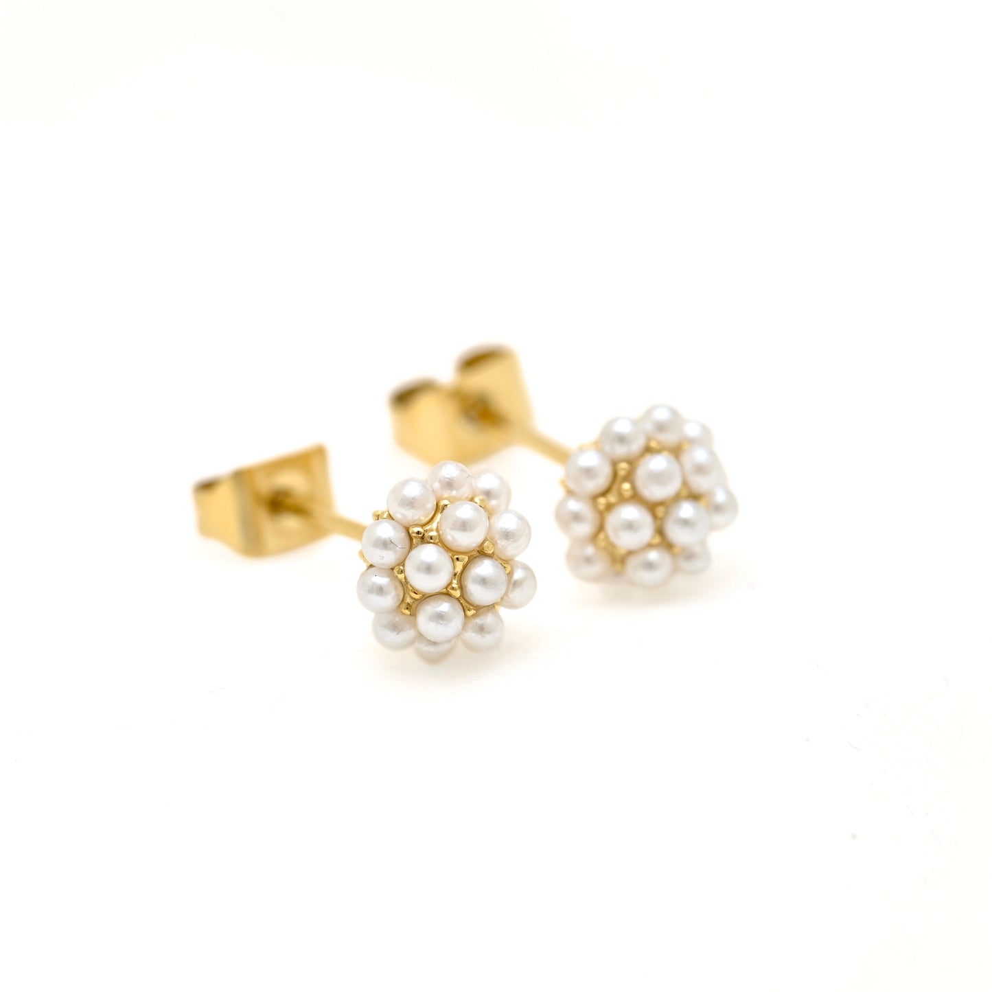 A pair of gold stud earrings featuring small white pearl clusters, photographed on a clean white background.