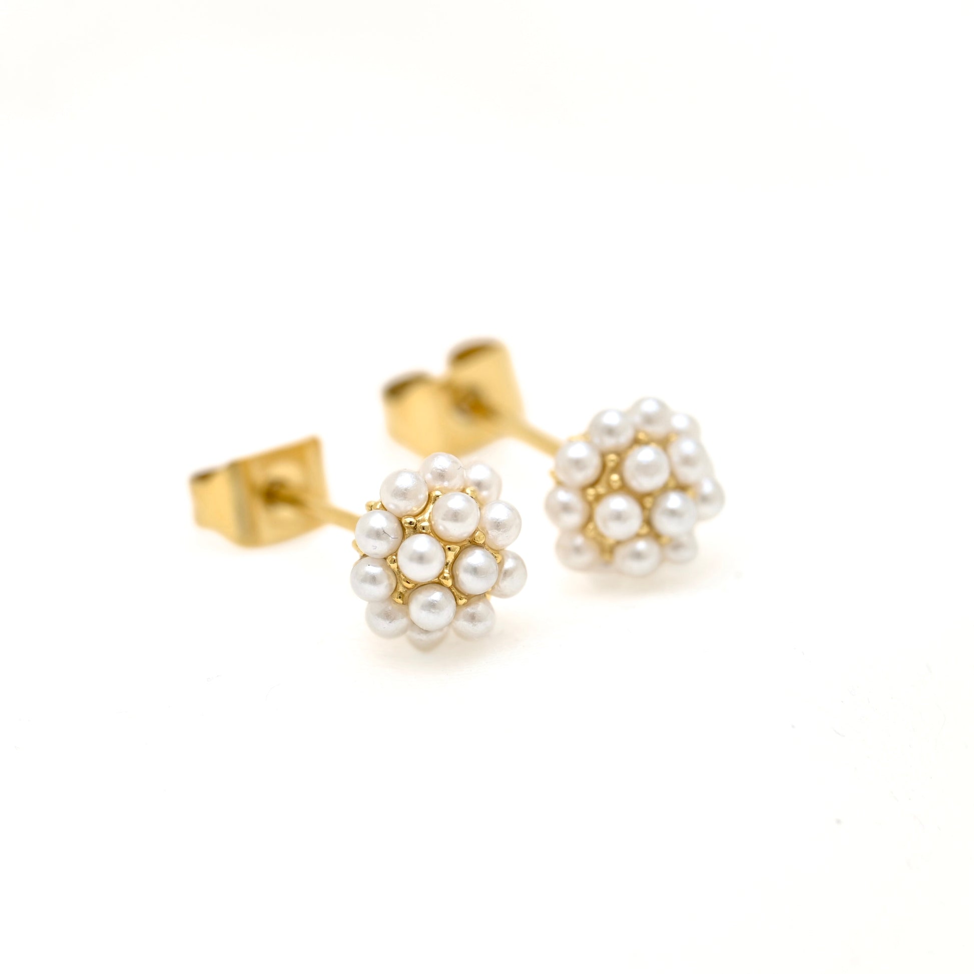 A pair of gold stud earrings featuring small white pearl clusters, photographed on a clean white background.