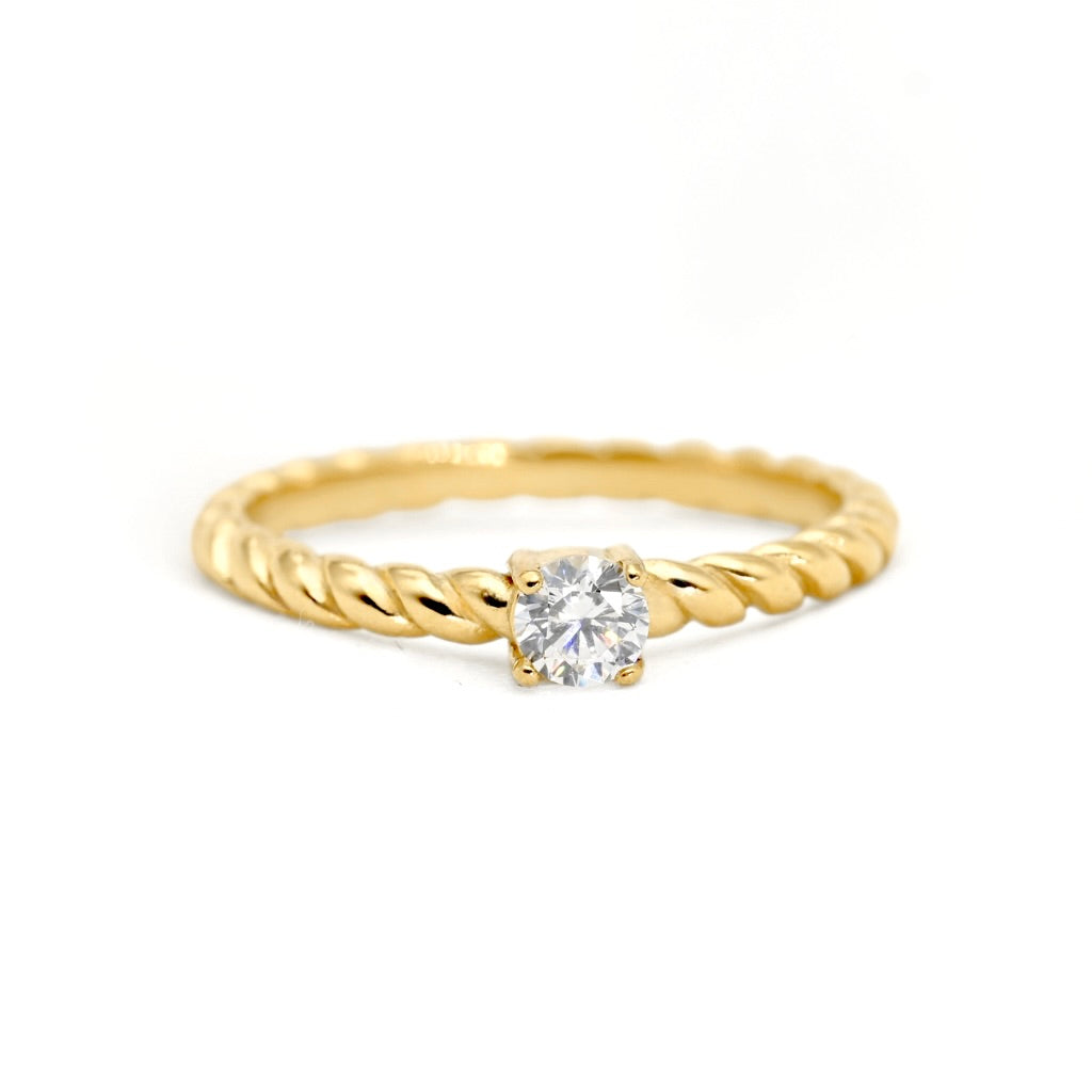 A yellow gold twisted rope ring with a single round brilliant-cut diamond set in a four-prong setting, photographed on a clean white background.