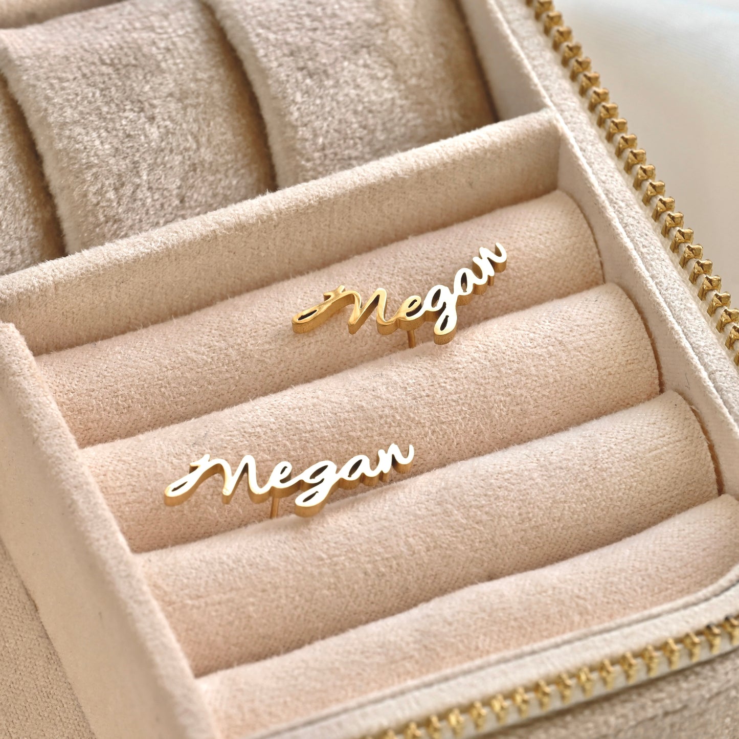 Gold 'Megan' nameplate earrings in a jewelry box