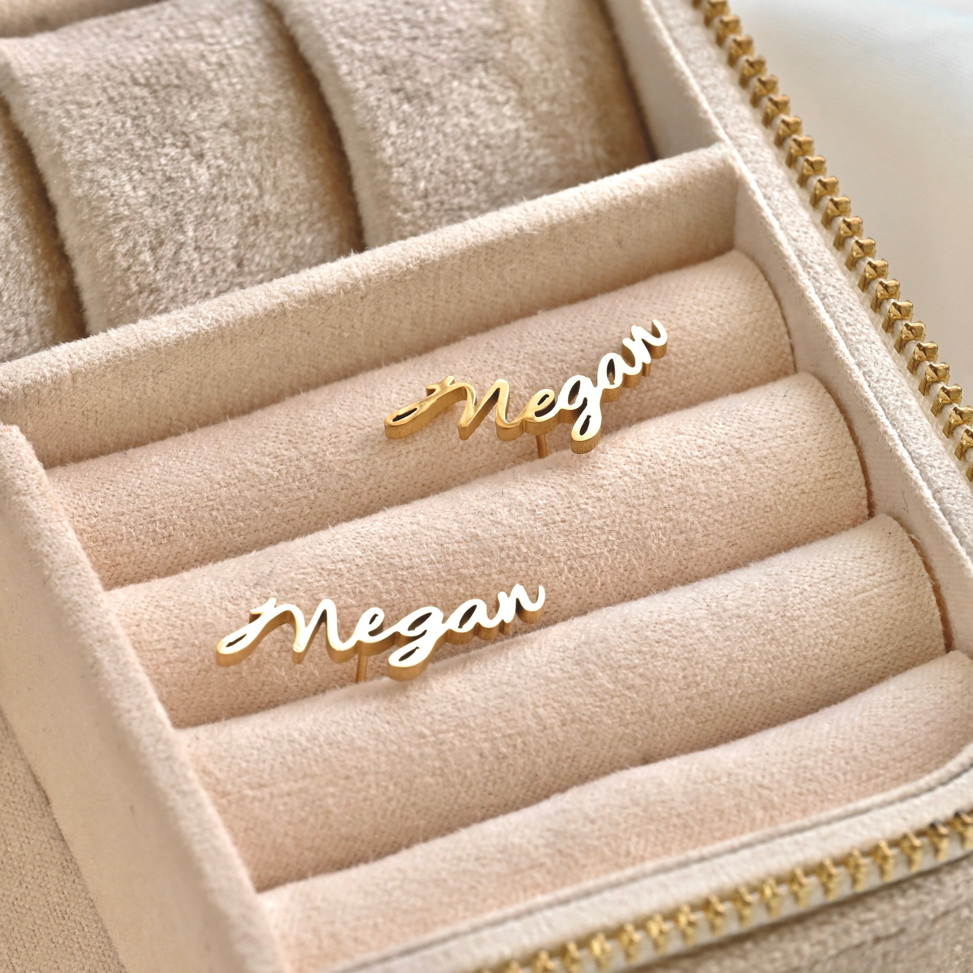 Gold 'Megan' nameplate earrings in a jewelry box