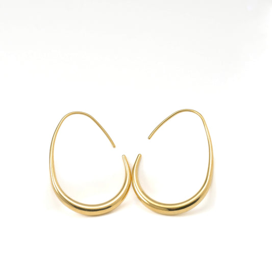 Gold teardrop hoop earrings on a white background