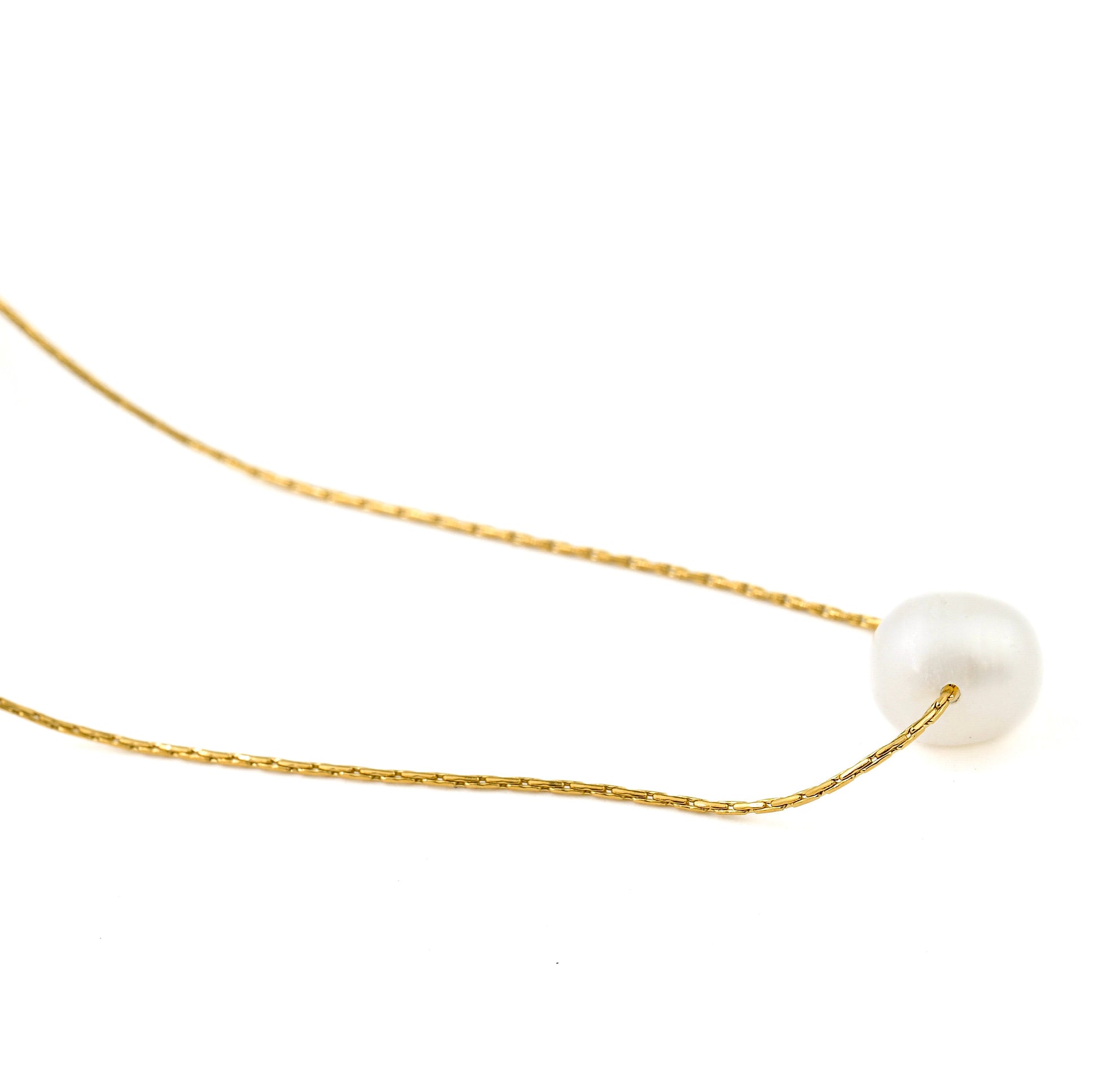 Gold necklace with a single medium  pearl on a white background