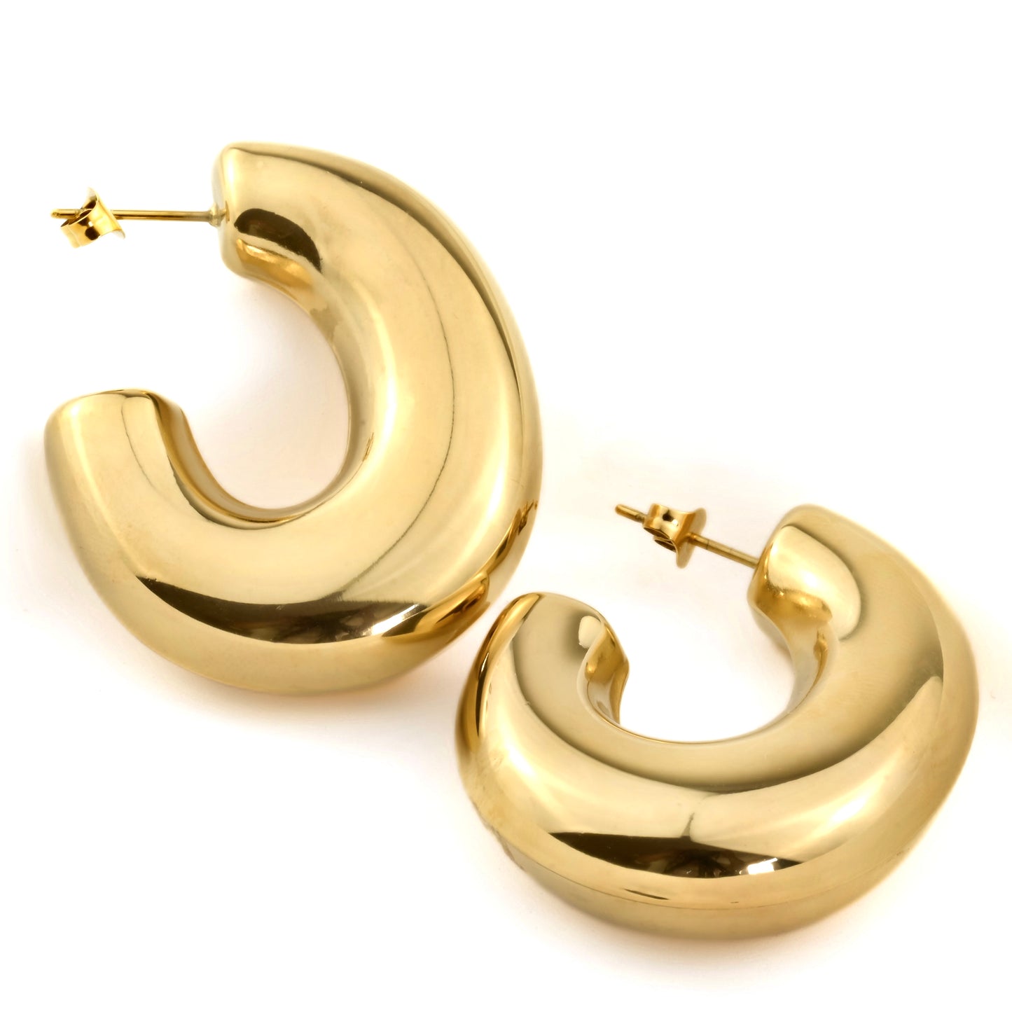 Bold oversized gold earrings on a white background