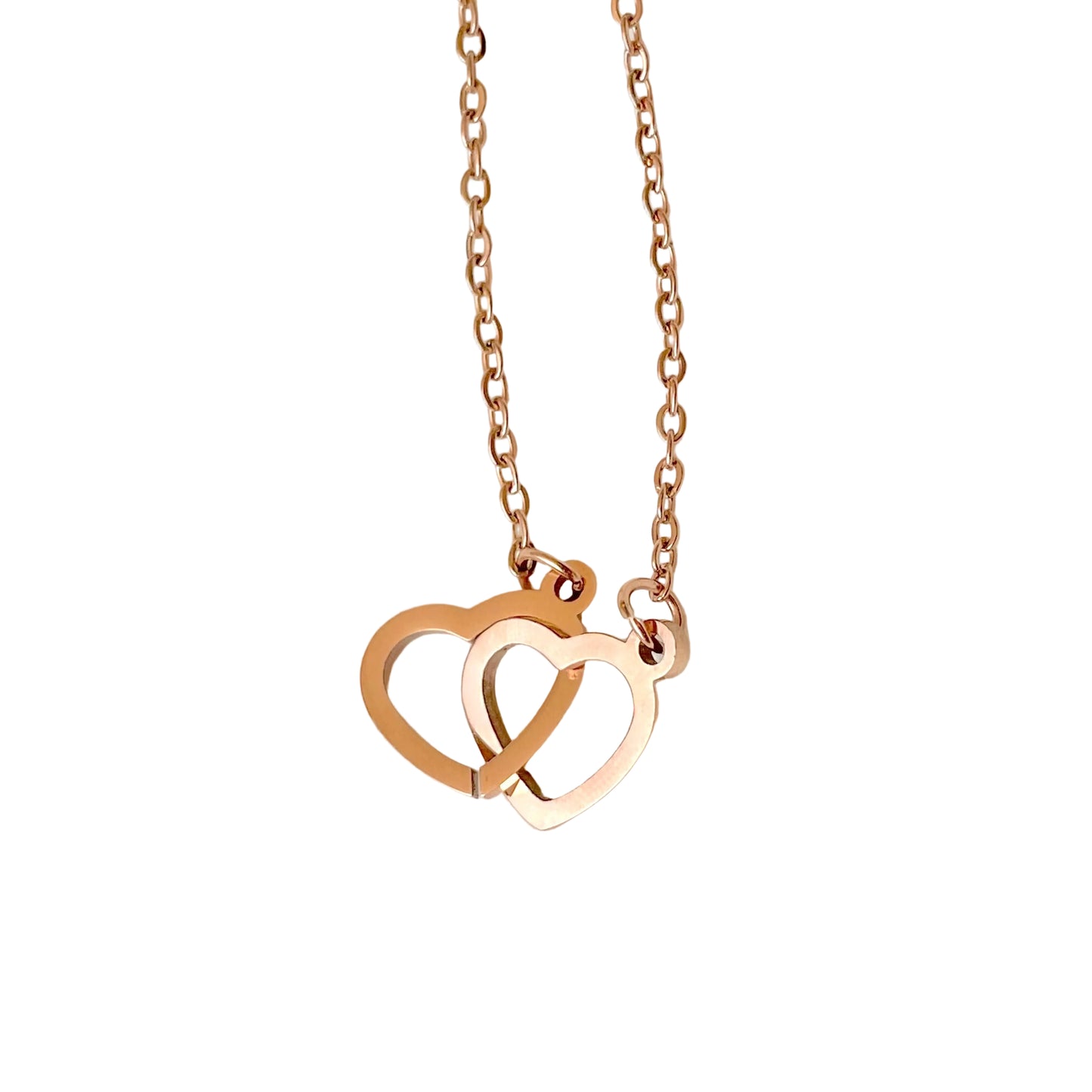 Rose gold necklace with interlocking heart pendants on a white background