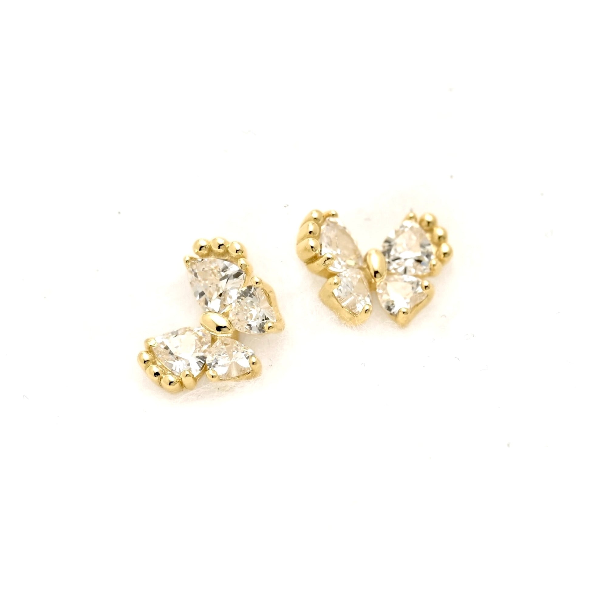 A pair of gold butterfly stud earrings with clear trillion-cut gemstones, displayed on a clean white background.