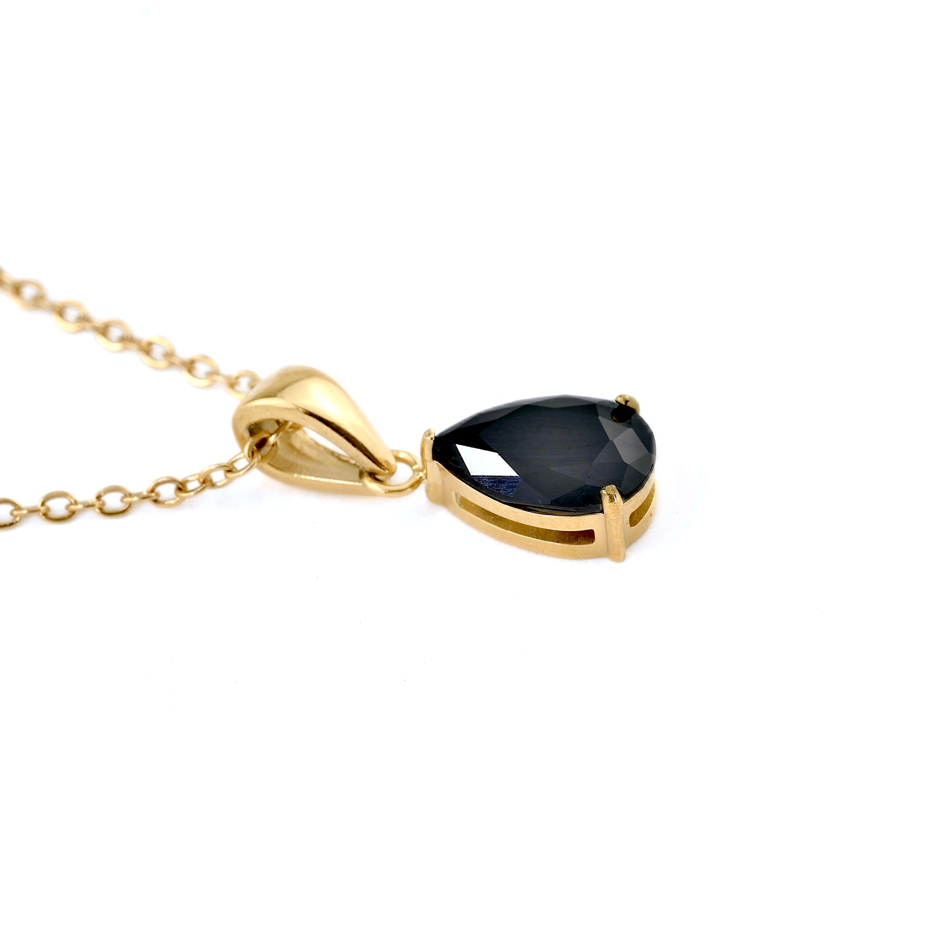 gold necklace with pear cut black onyx on a white background
