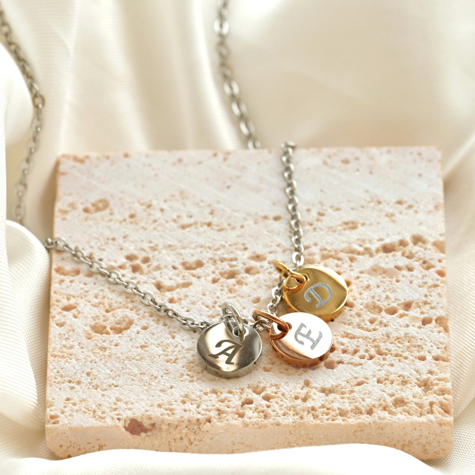 Necklace with charms on a textured stone with a soft background