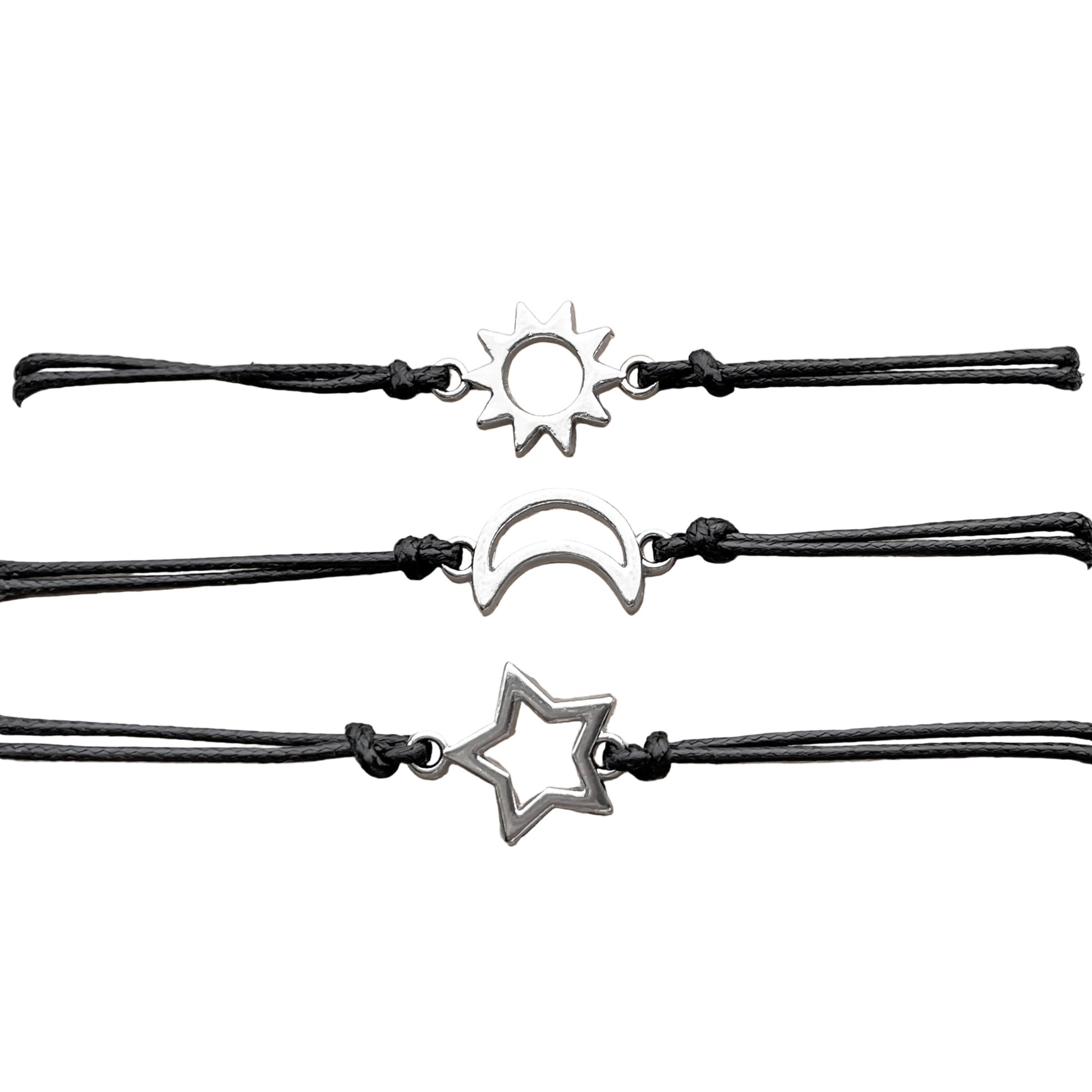Set of black rope wish bracelets with silver star, moon, and sun charms on a white background