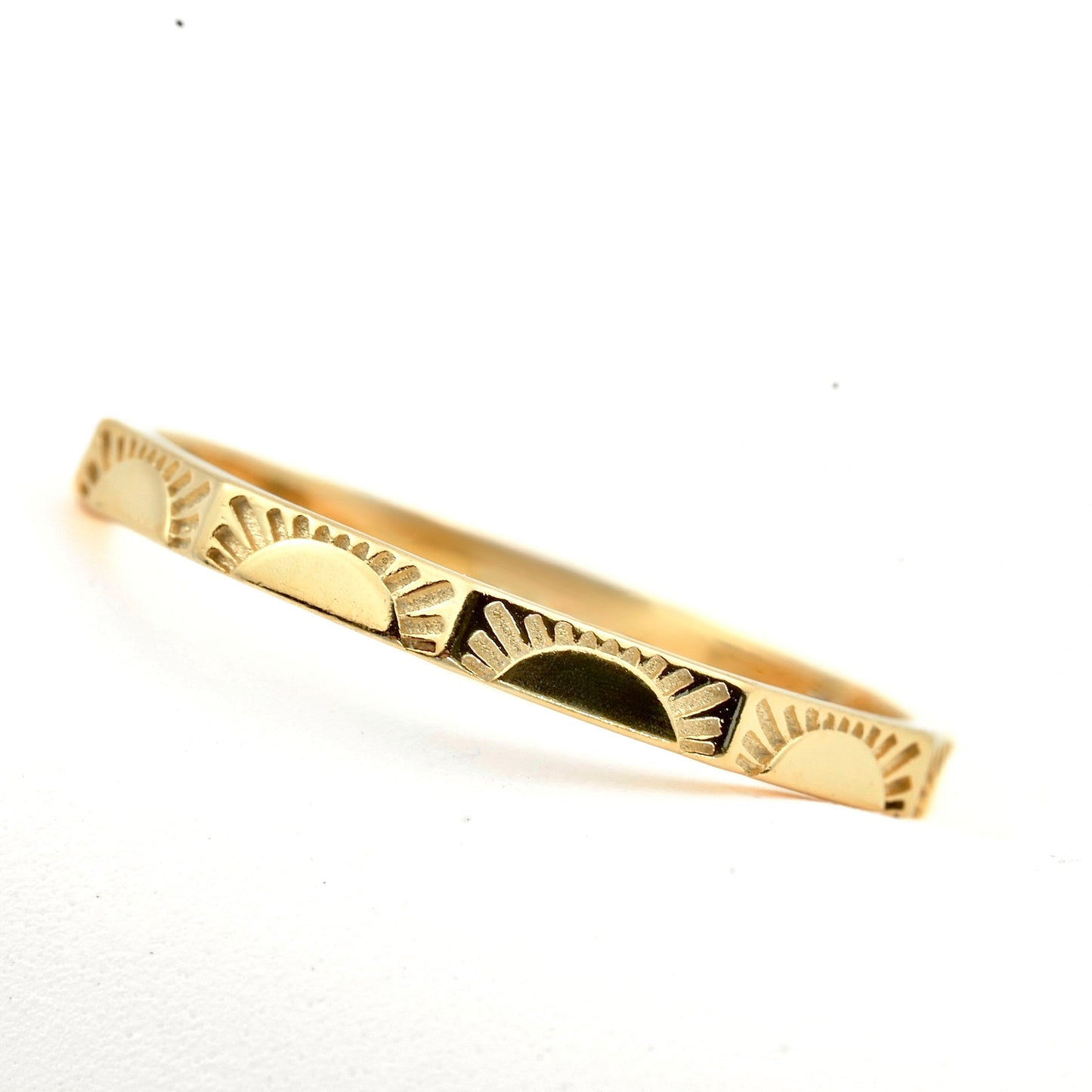 Gold sun ring on a white background