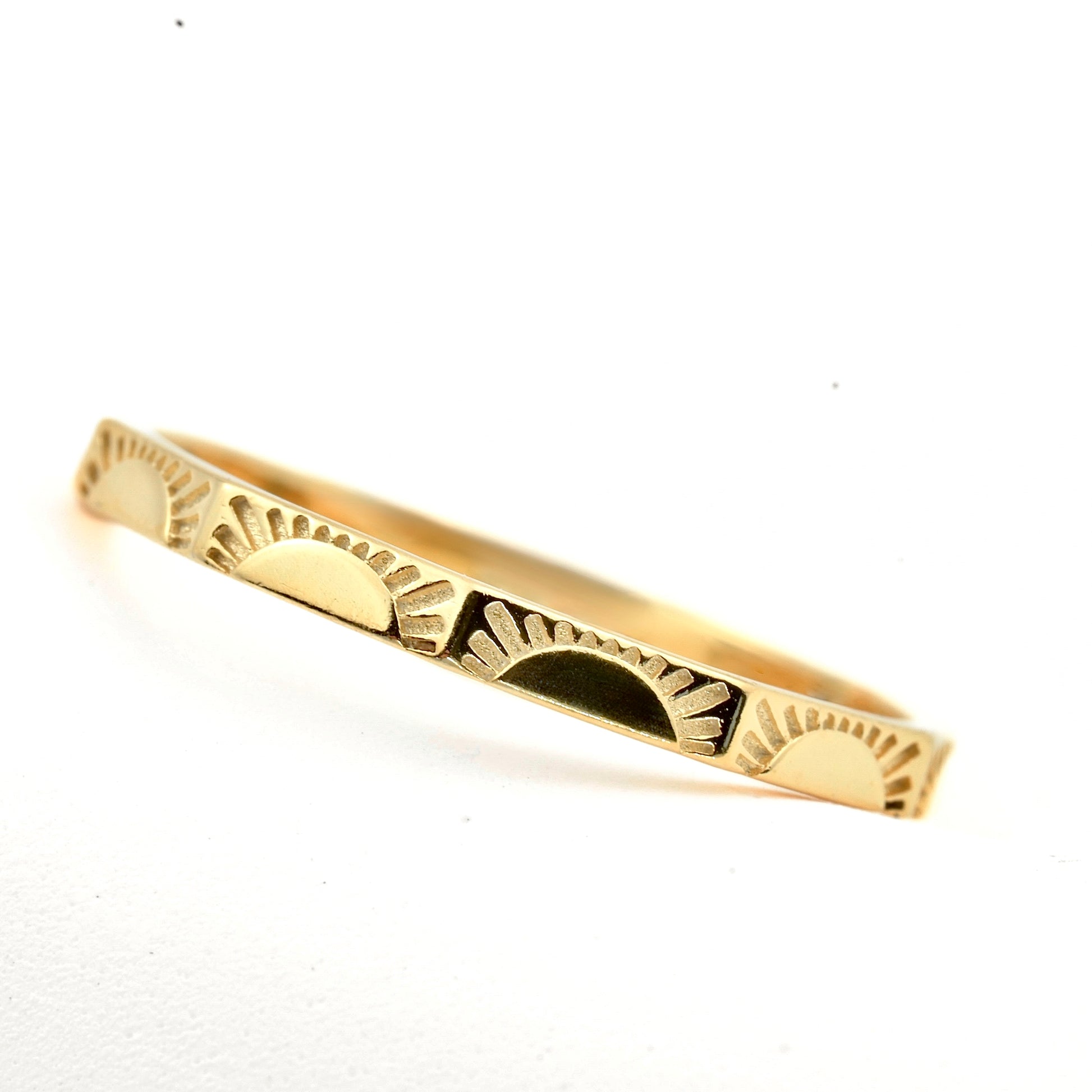 Gold sun ring on a white background