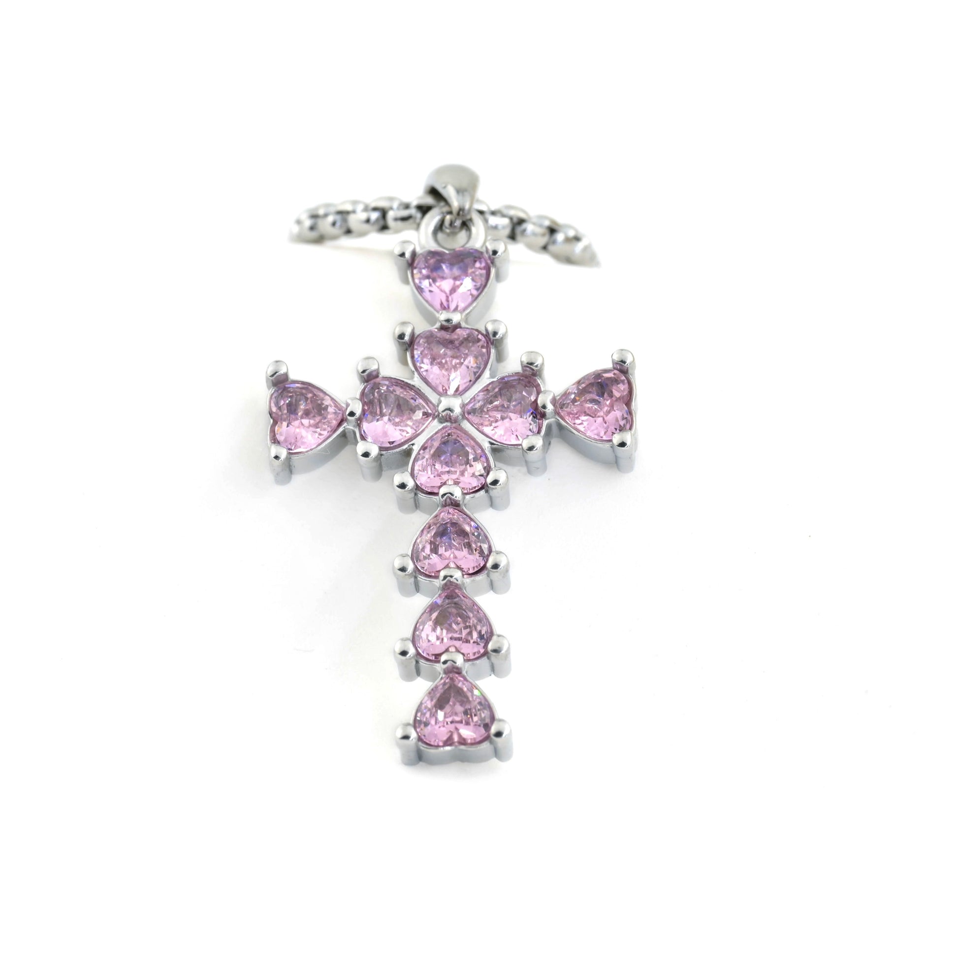 Silver cross pendant with pink gemstones on a white background