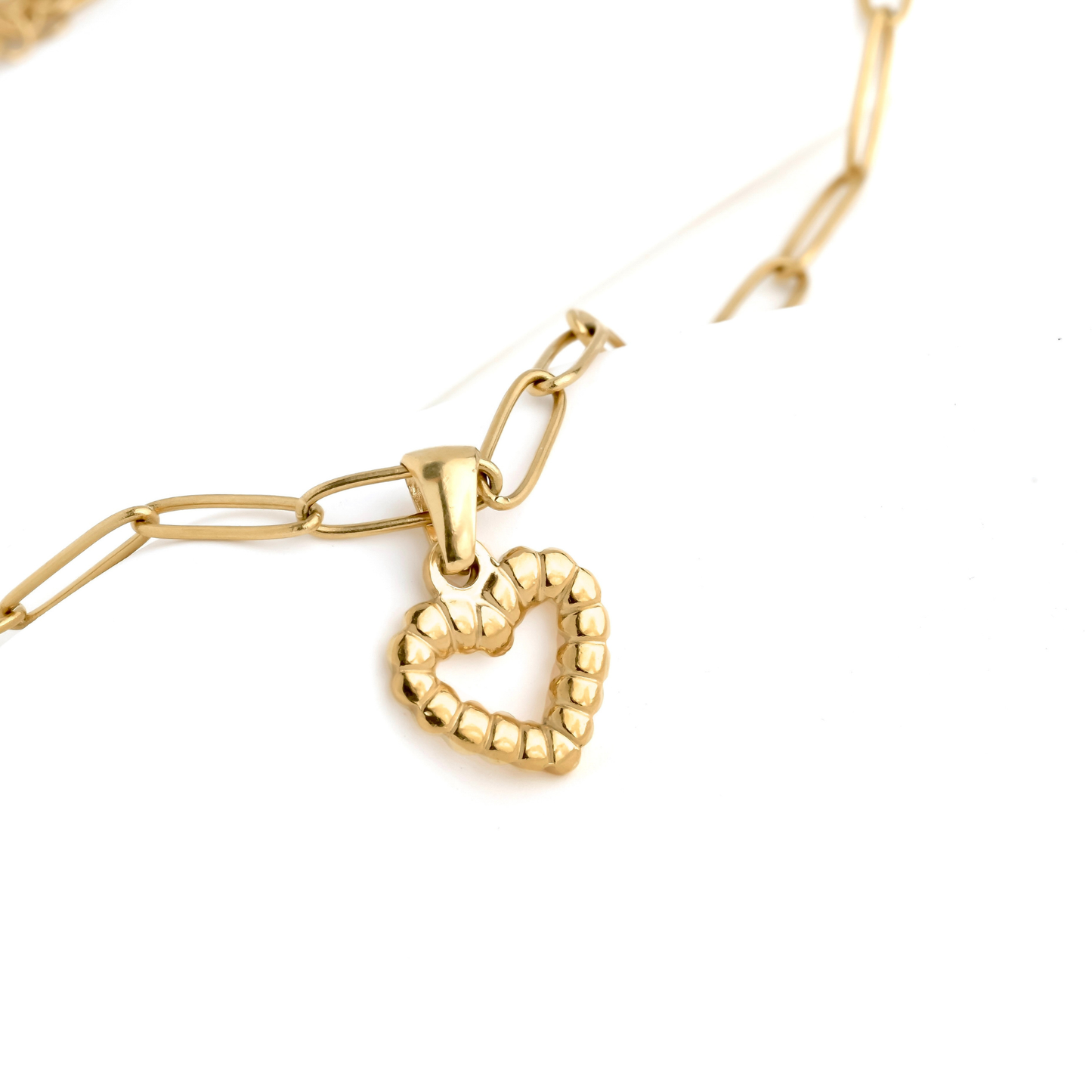 Small textured gold heart necklace with a paperclip chain on a white background
